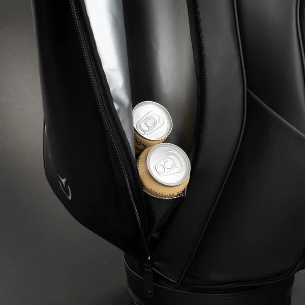 Two cans inside the cooler lined side pocket of a black lux cart bag