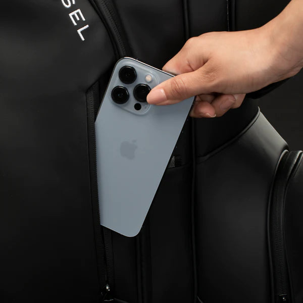 A model placing a blue iPhone into the side pocket of a lux cart bag