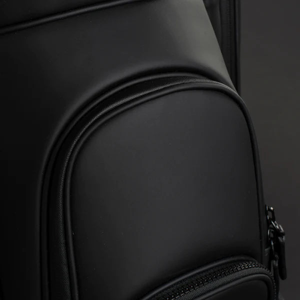 A close up image of the pockets of a black lux cart bag.