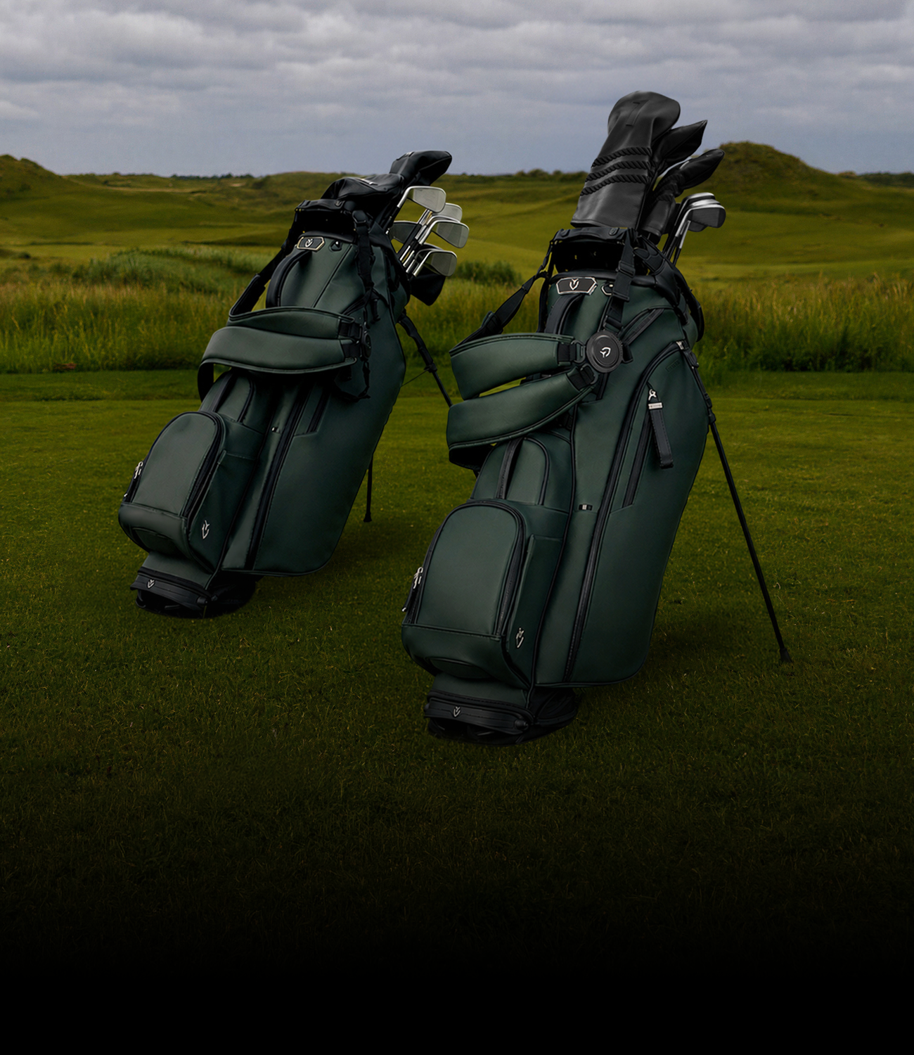 Two green golf bags standing on a golf green