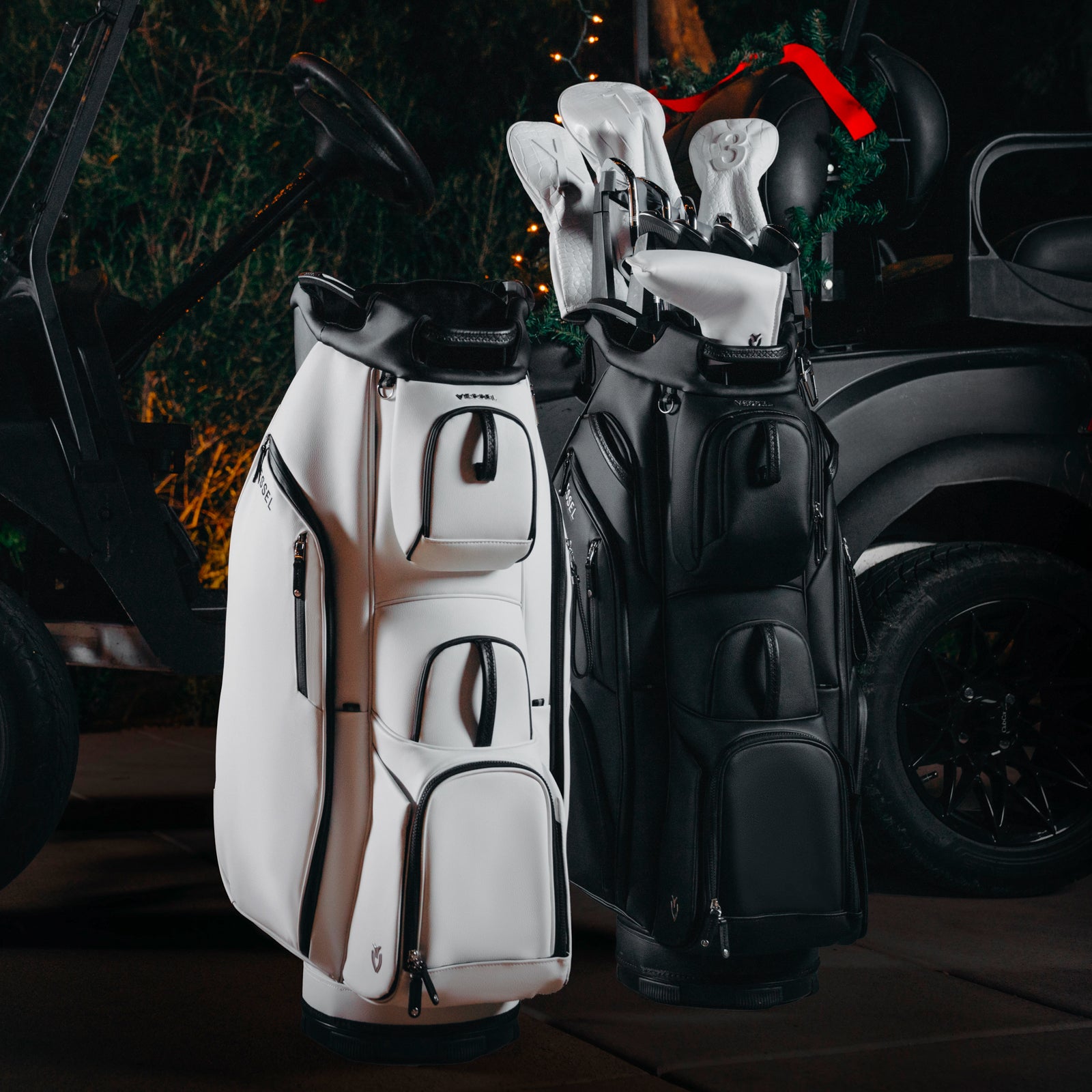 Black and White golf cart bags next to golf cart Christmas decor