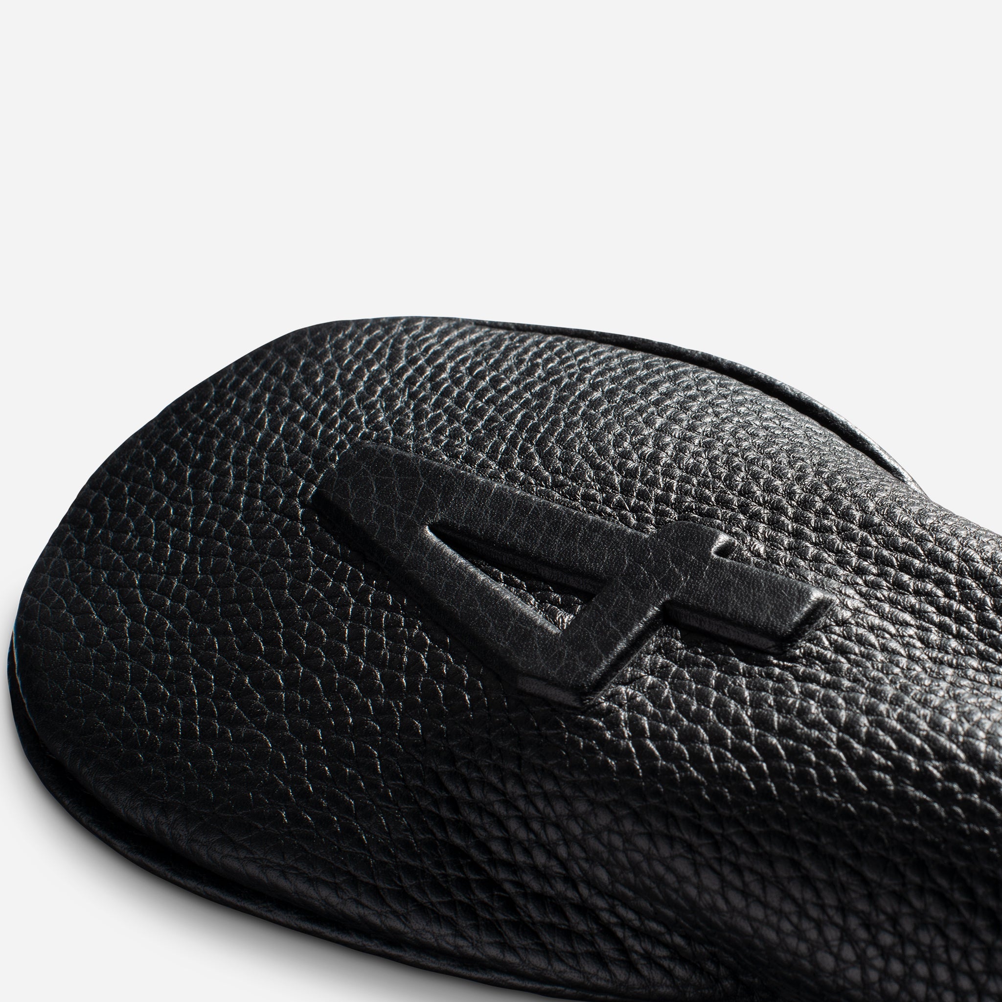 close up of embossed number on striped black pebbled leather headcover - 4 hybrid #size_4-hybrid