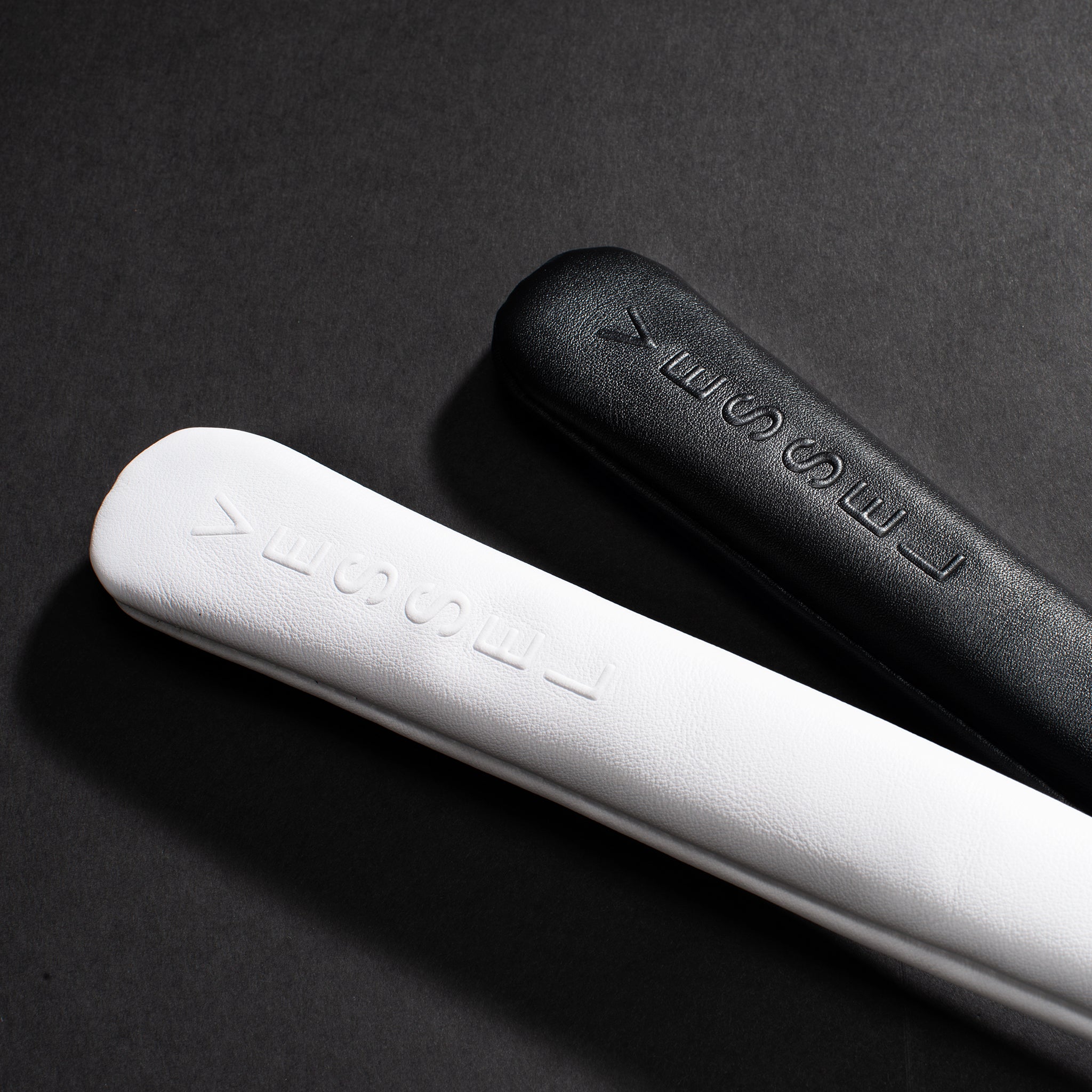 Black and White Alignment Stick Embossé Covers against a black background