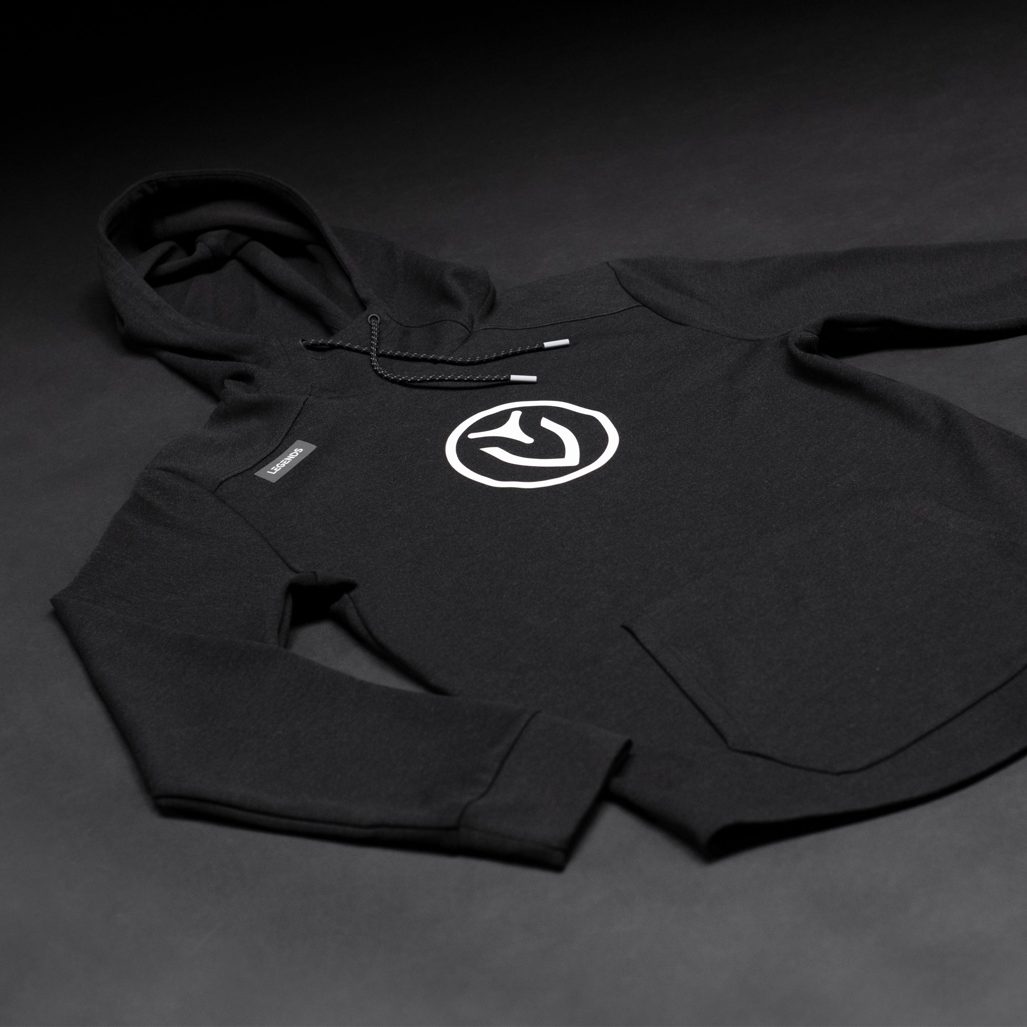Black VESSEL hoodie laid flat on a black background