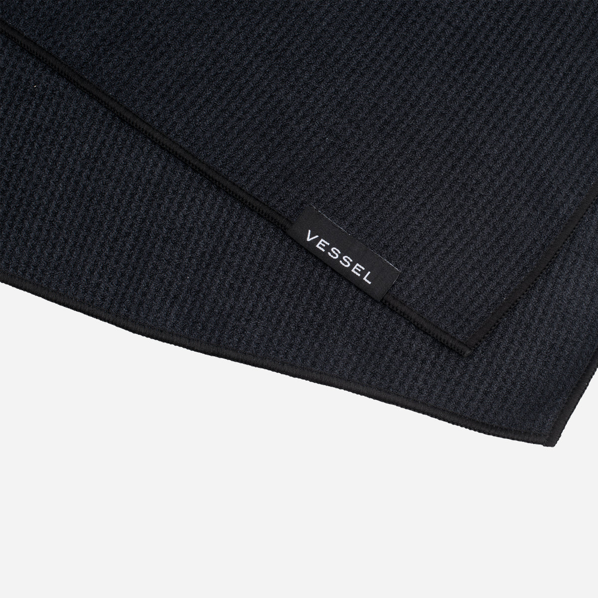 Close up of logo tag on black Magnetic Golf Towel | 20" x 20" #color_black