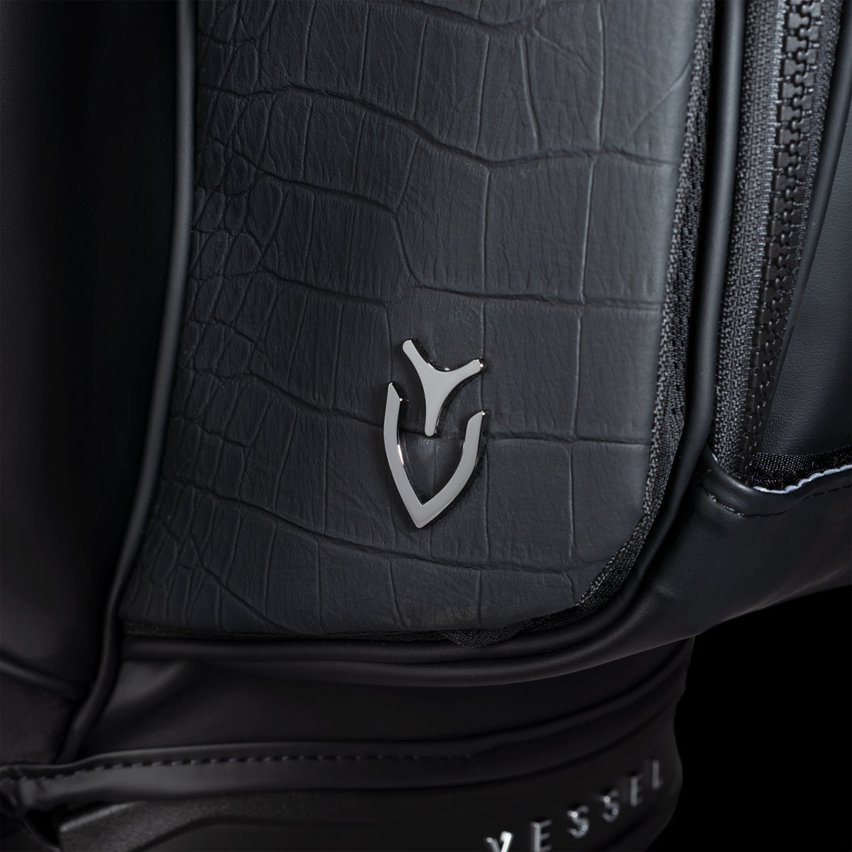 Close up of croc leather texture on Player VI Series Croc Black Stand Bag water bottle pocket