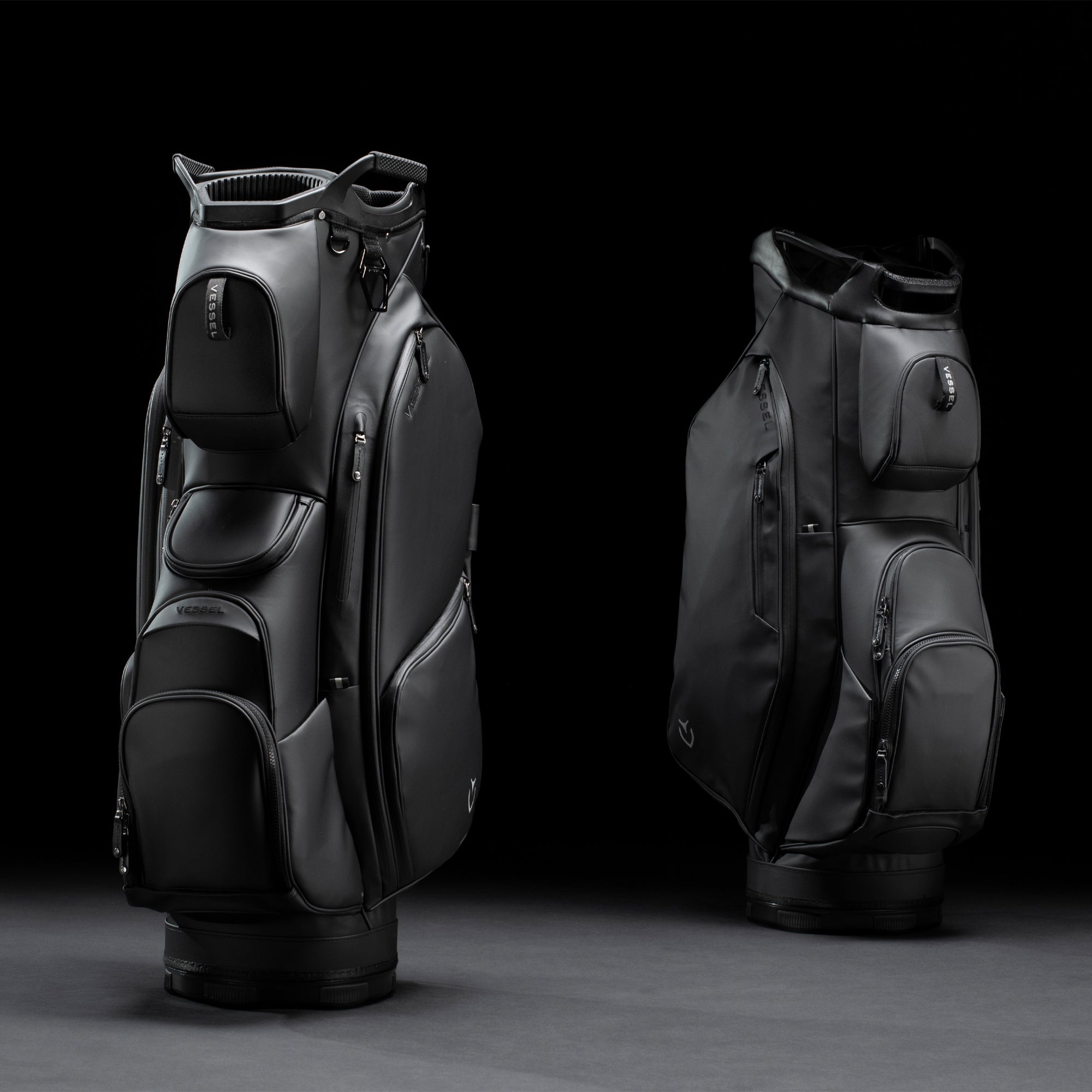 Two black golf cart bags in black studio