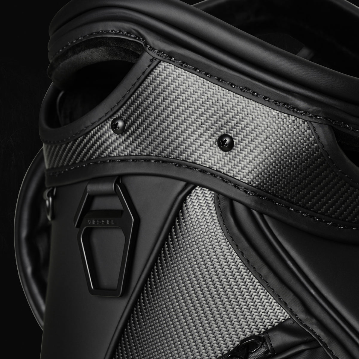 Close up shot of the top of a black carbon fiber golf bag
