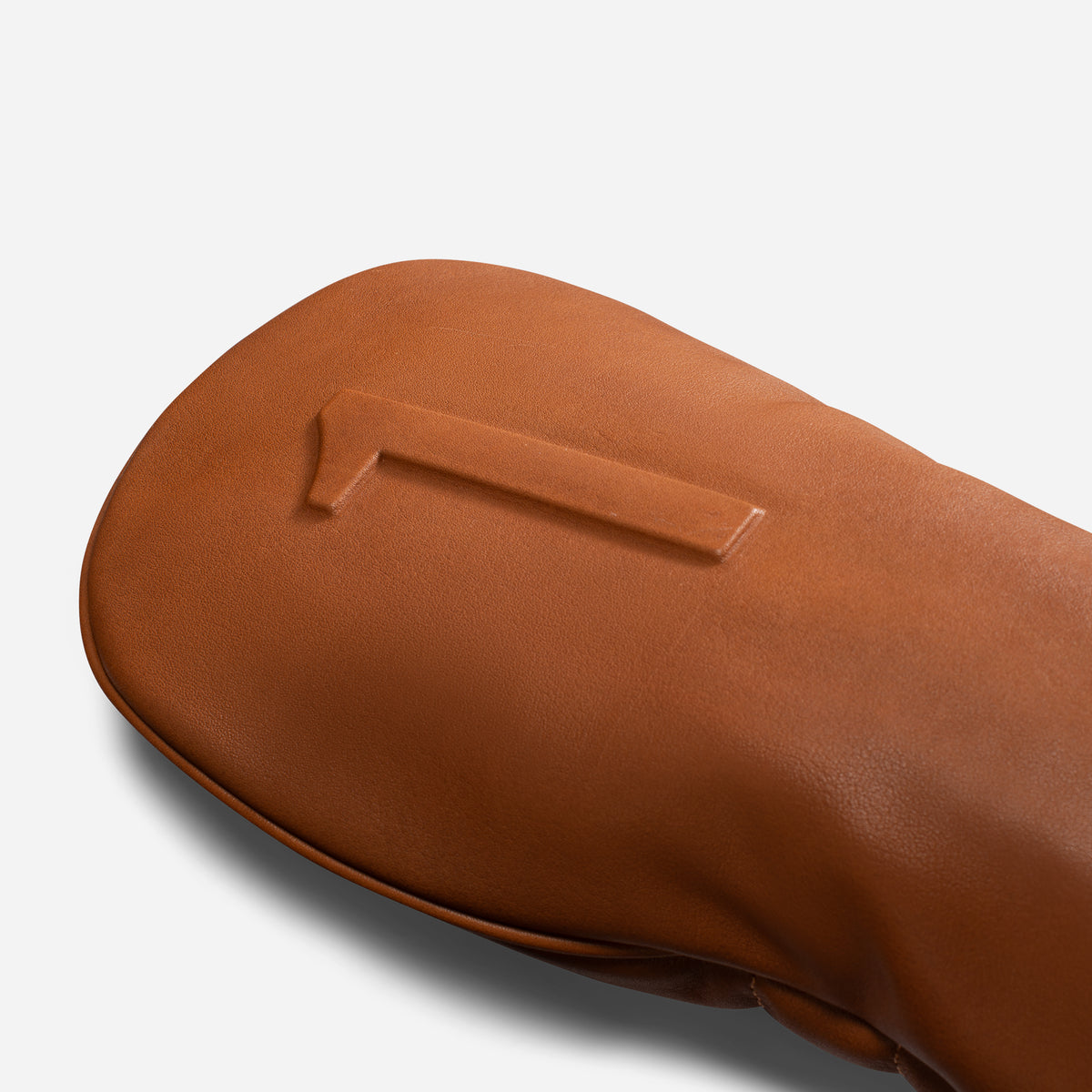 close up of embossed number on smooth brown leather headcover - driver #size_driver