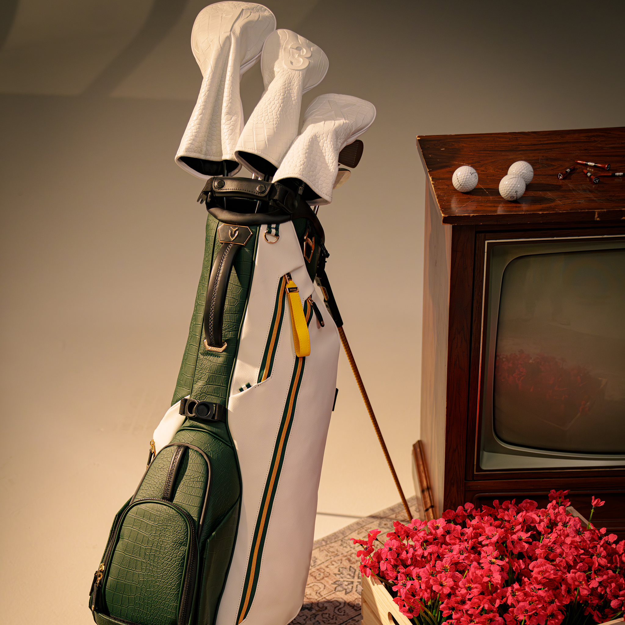 2026 Season Opener Lux Stand standing next to old tv an with white leather golf club headcovers