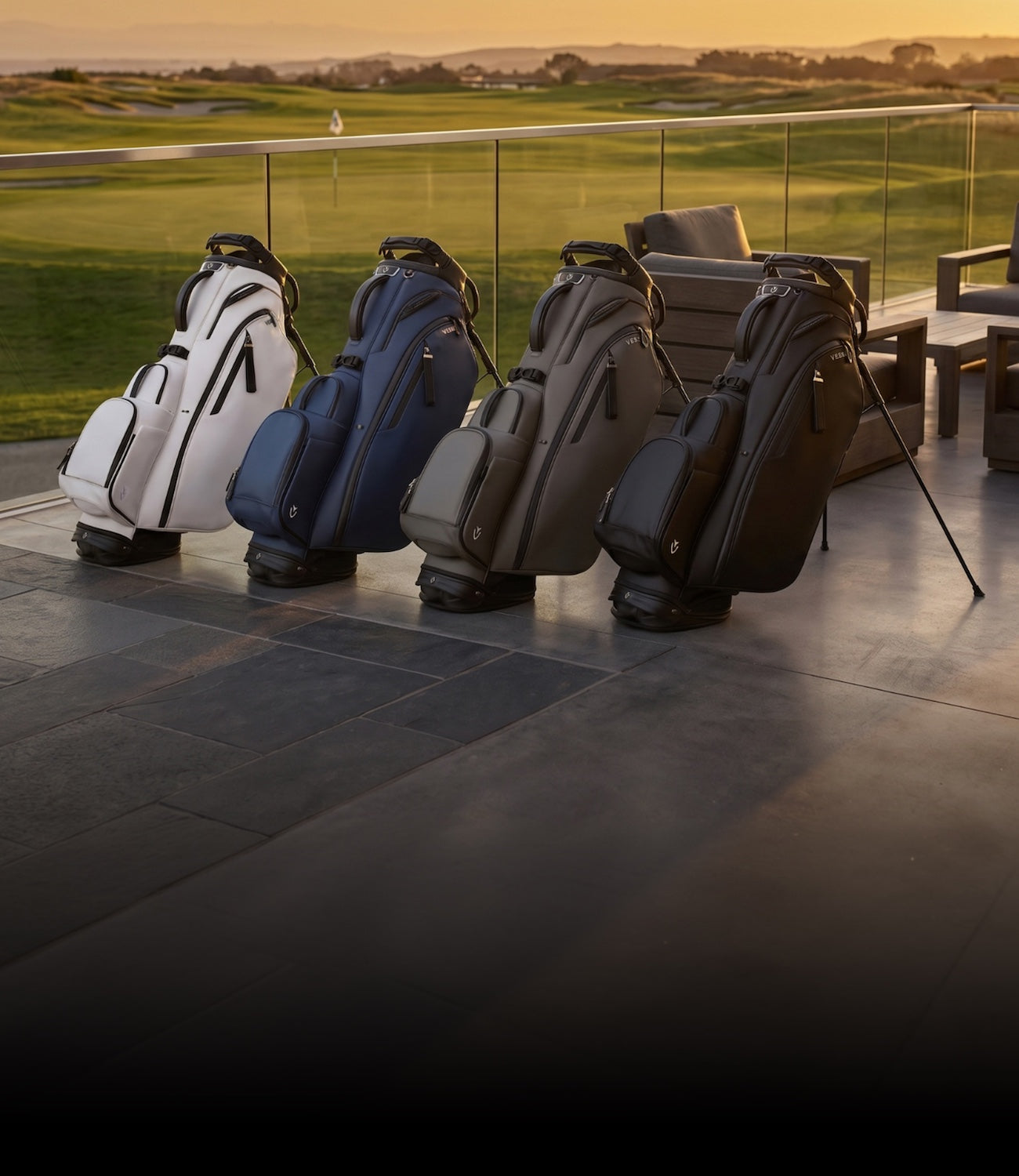 Four leather VESSEL golf bags on a fancy porch