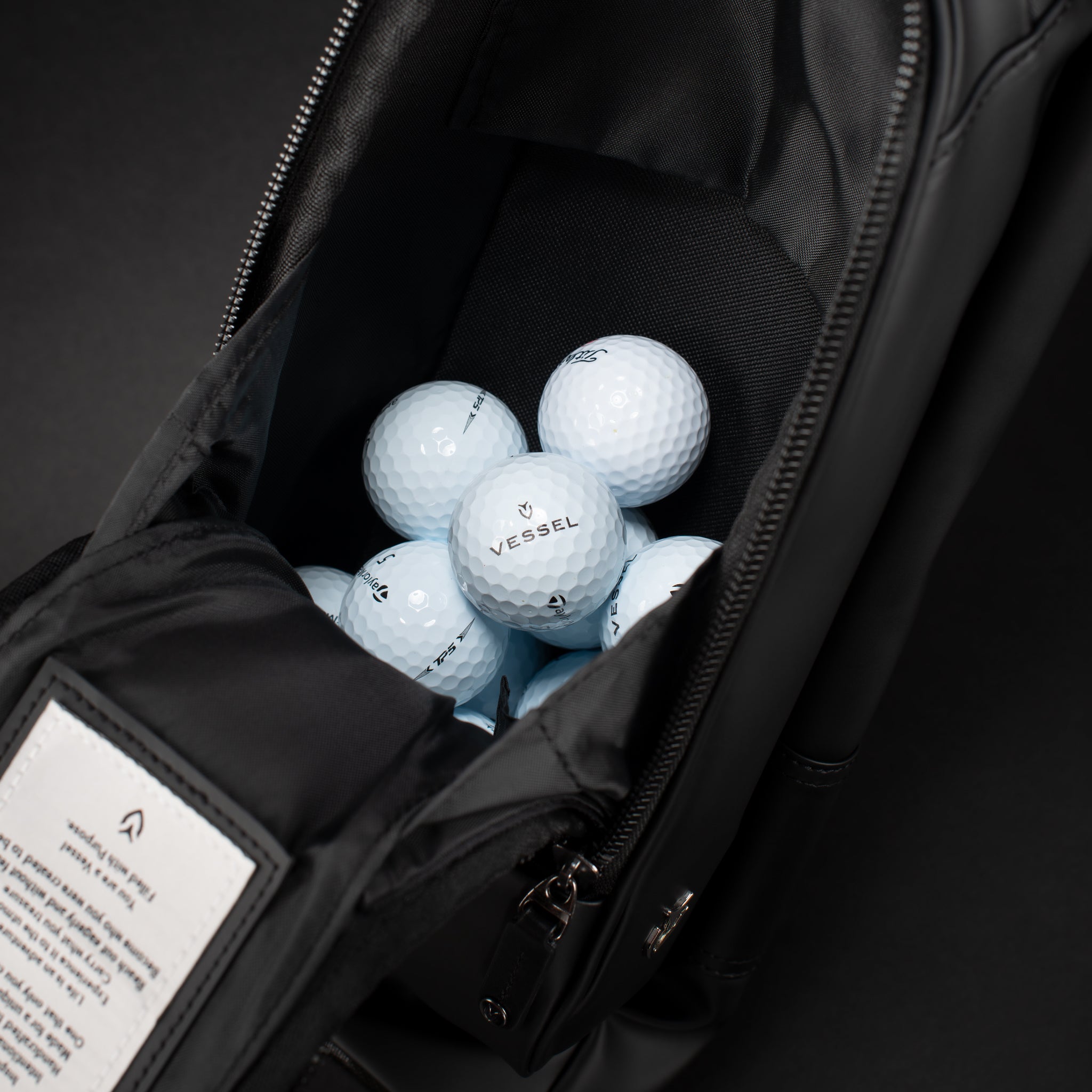 Golf bags inside ball pocket on black pencil stand bag