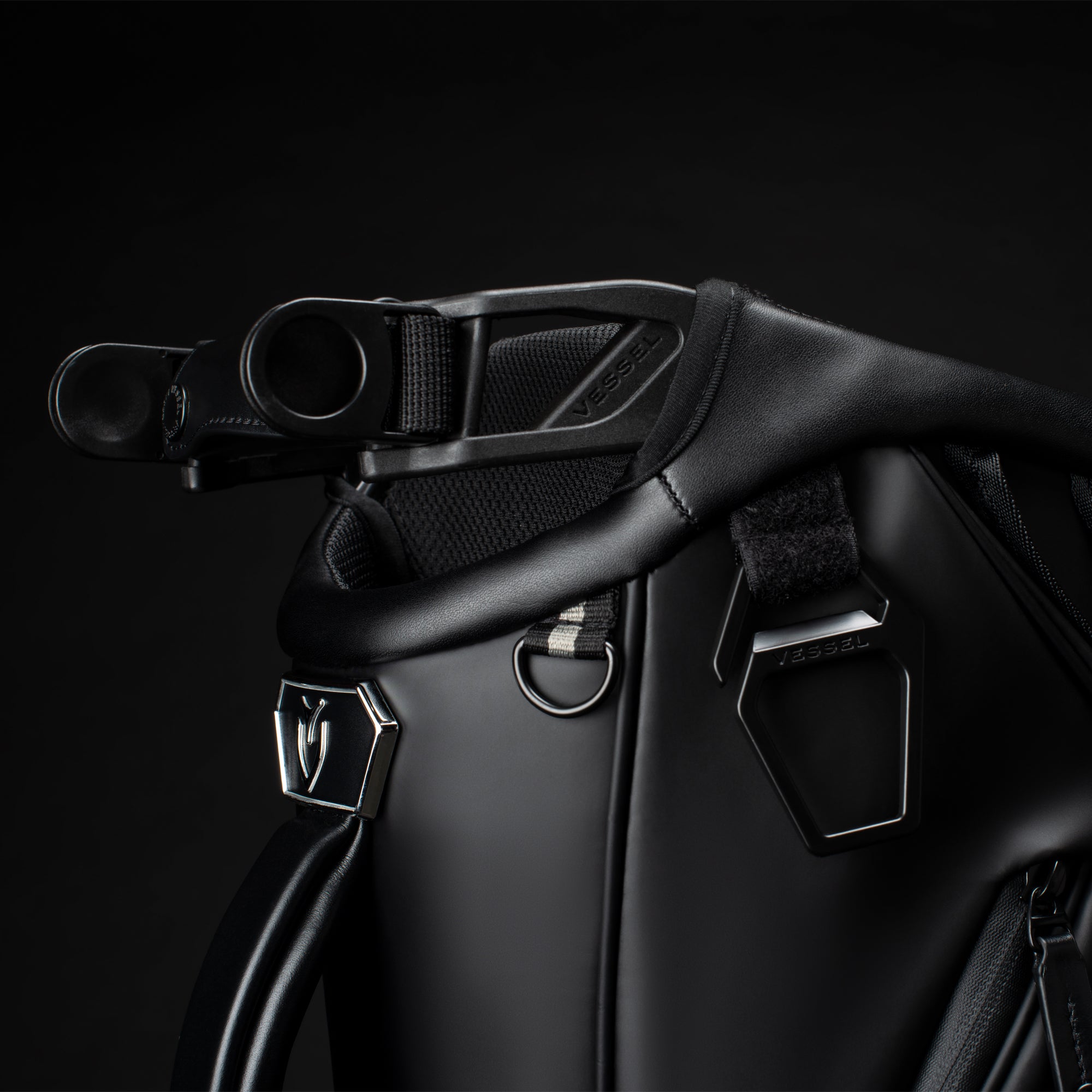 Close up photo of the high strap-attachment points on the top design of a black Player IV Pro in a black studio