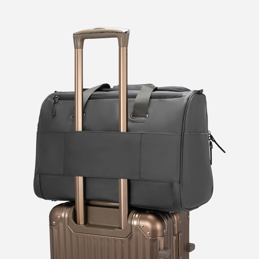 Grey Signature Weekender on top of suitcase #color_pebbled grey