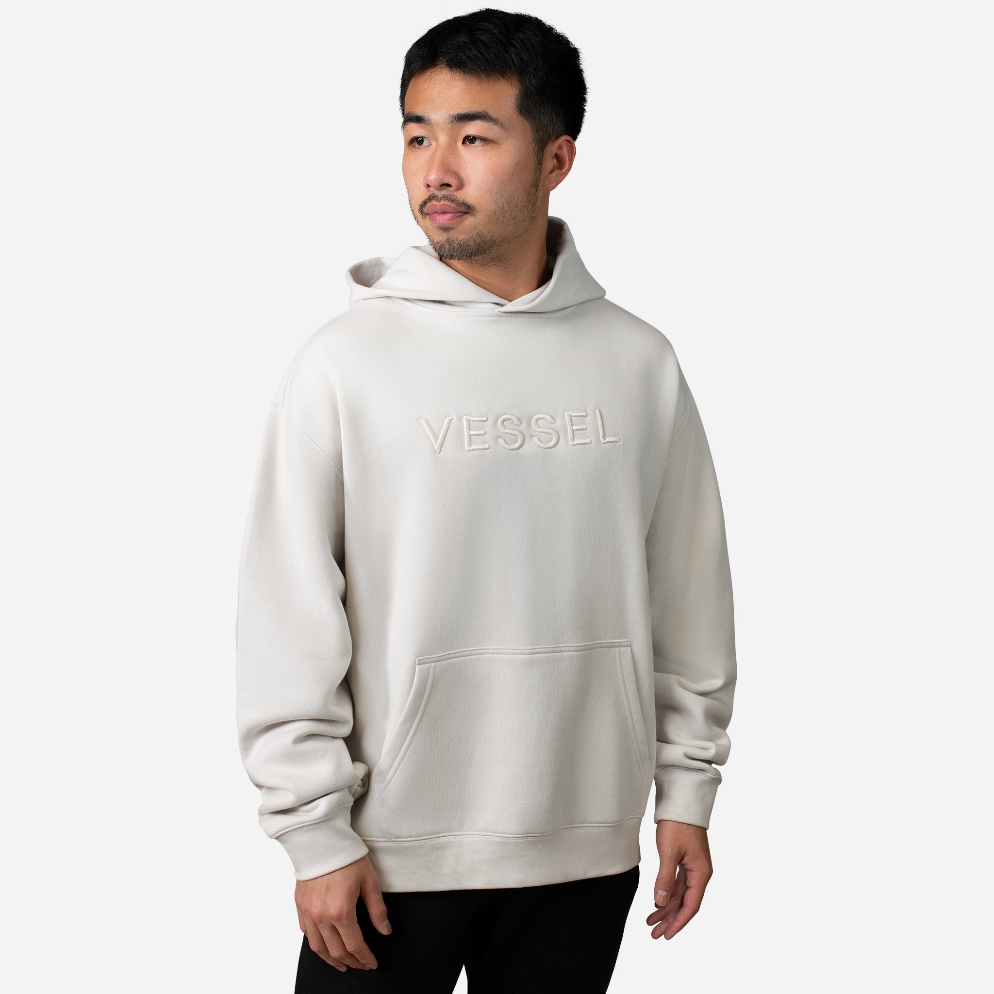 Man wearing cream VESSEL Hoodie #color_cream