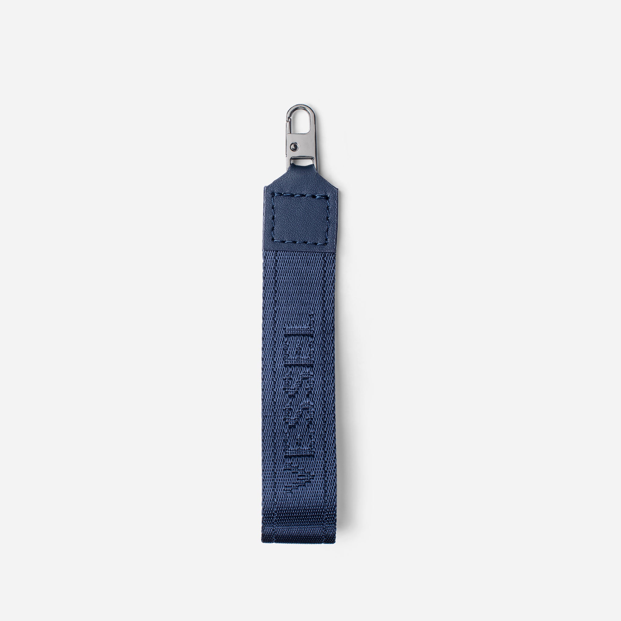 Navy jacquard fabric loop zipper pull against a white background