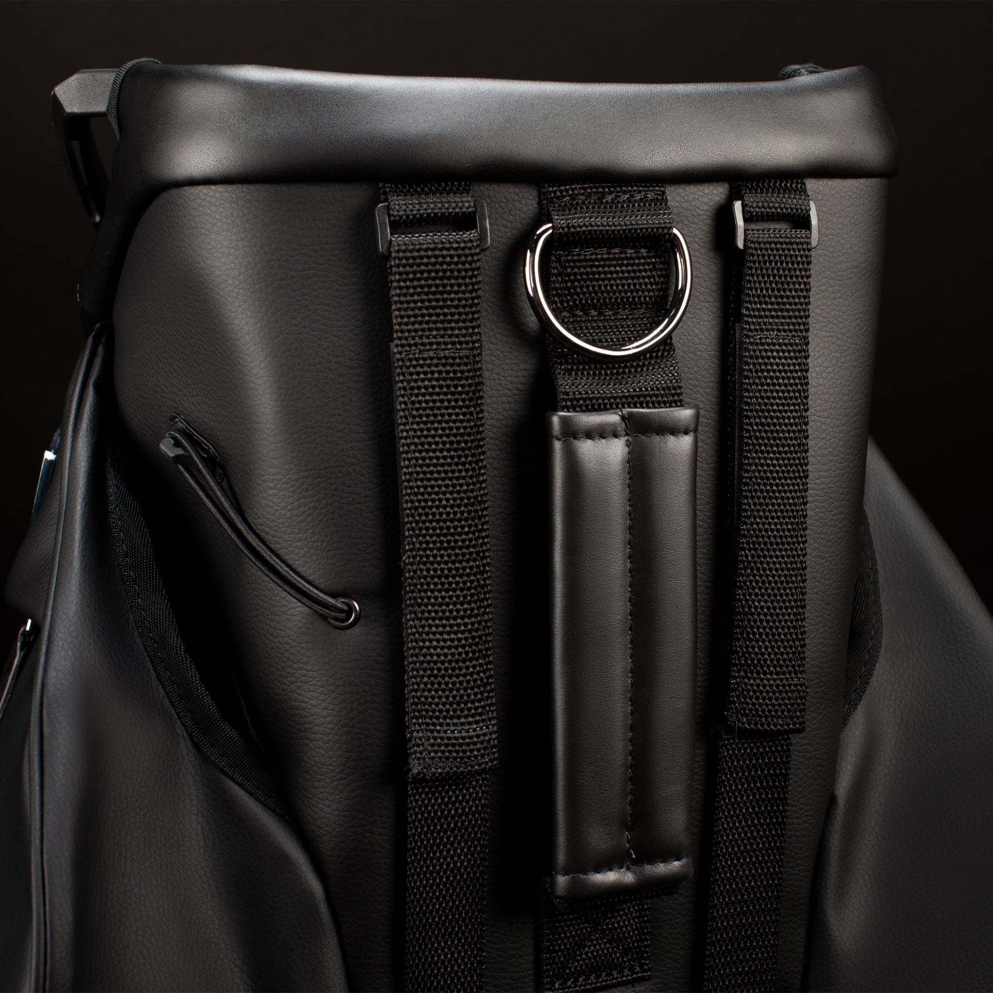 Backside of black leather golf cart bag with bracket cart straps