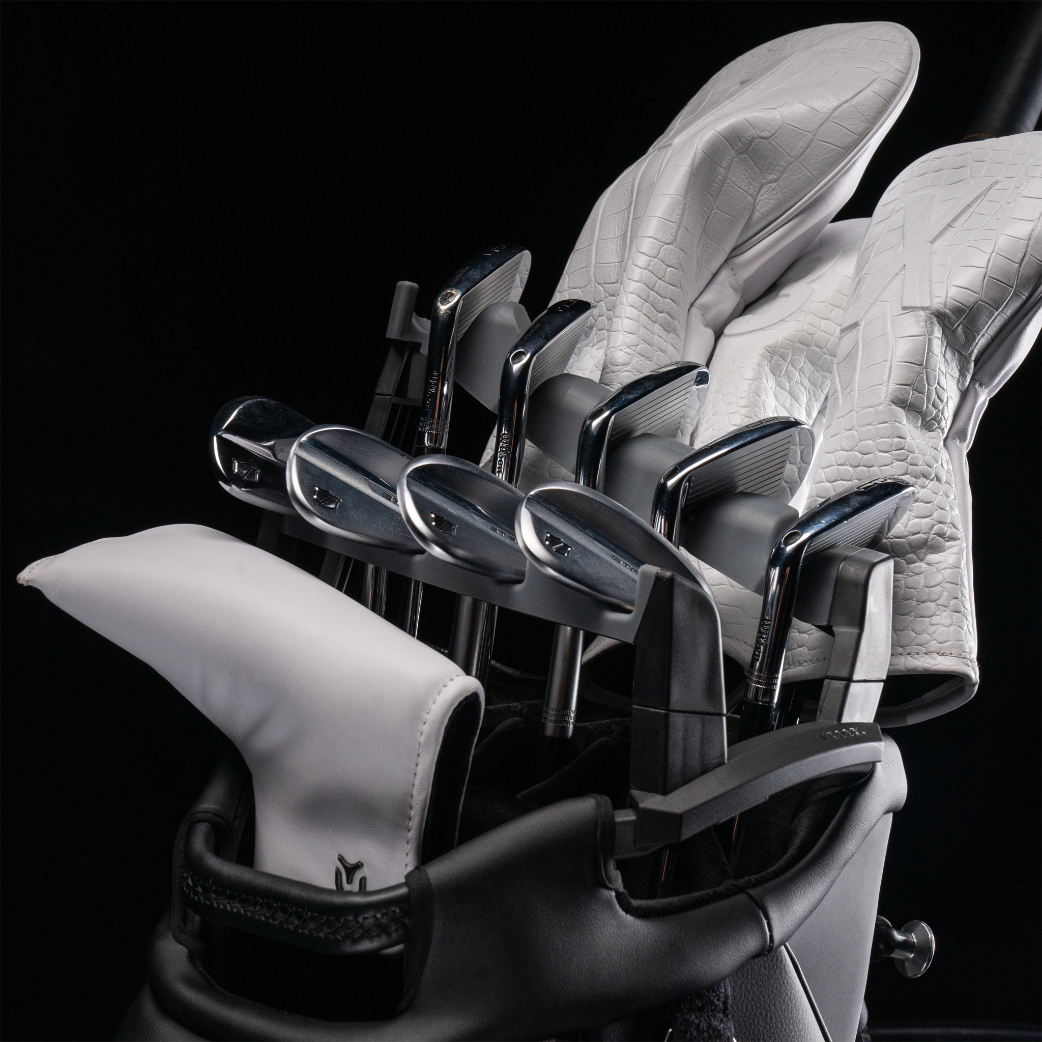 Golf clubs neatly displayed in Vessel Golf Club organizer on a black background