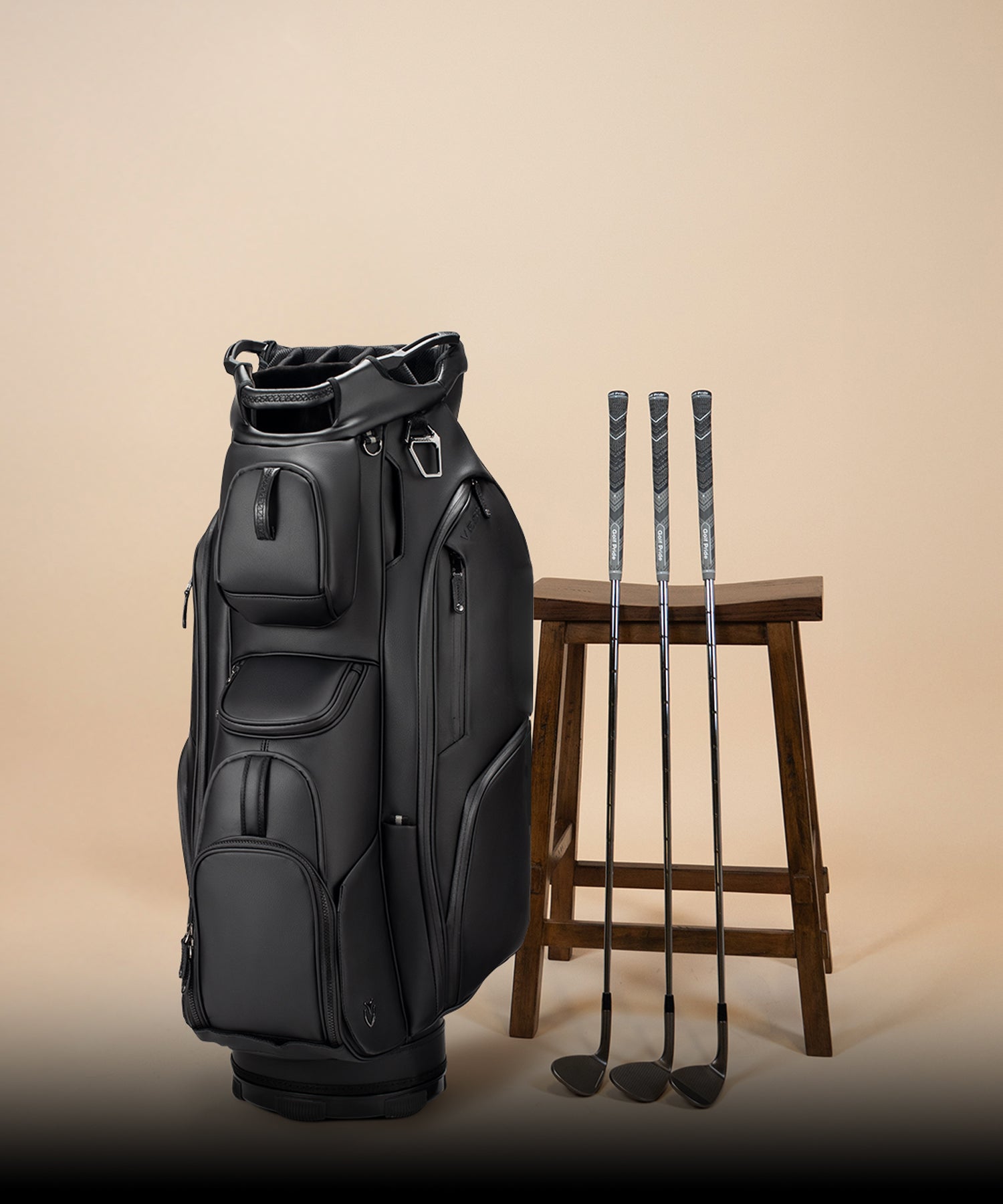 Lux Cart II next to three golf clubs and wooden stool