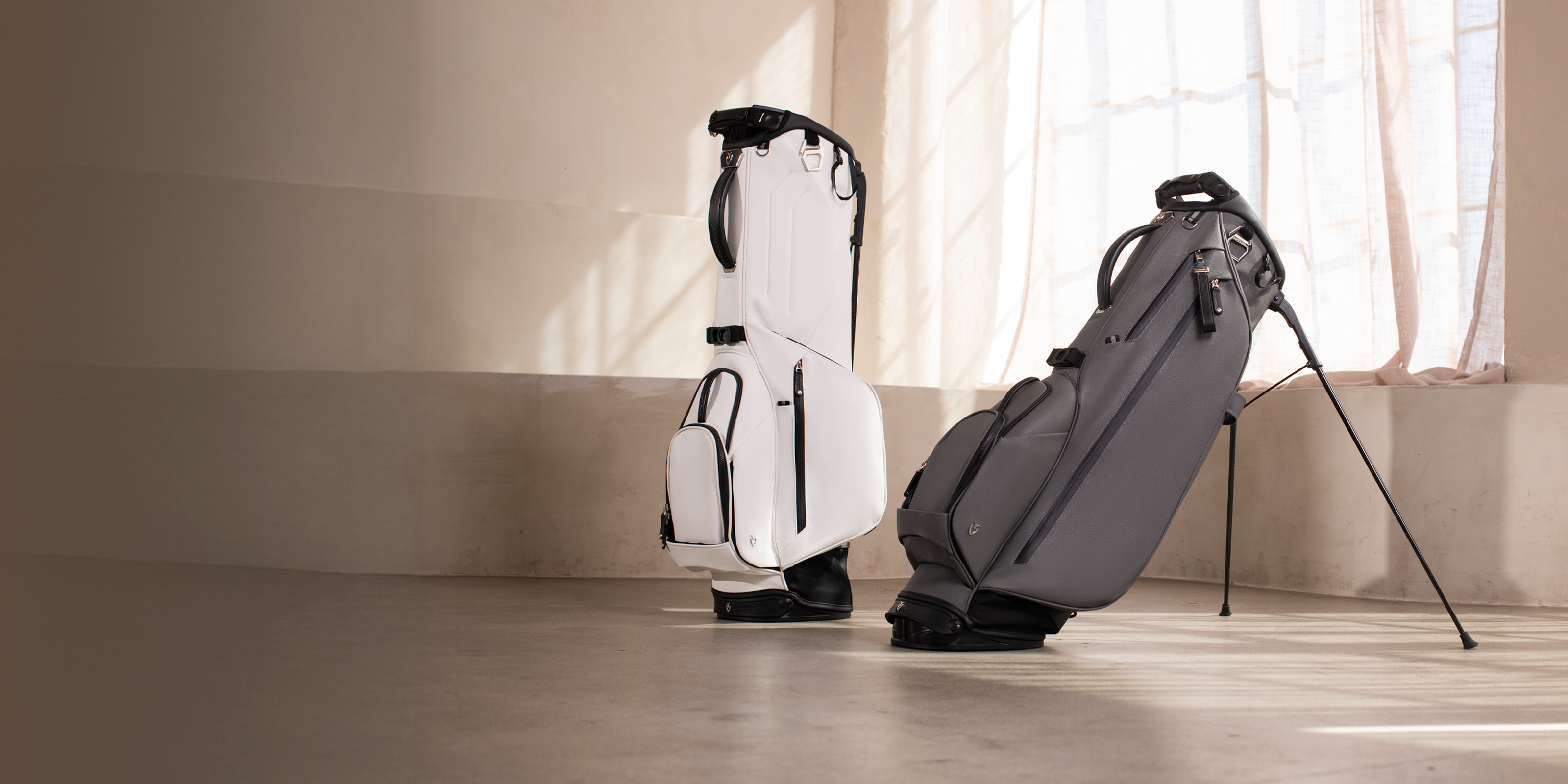 Two golf bags standing in a concrete room