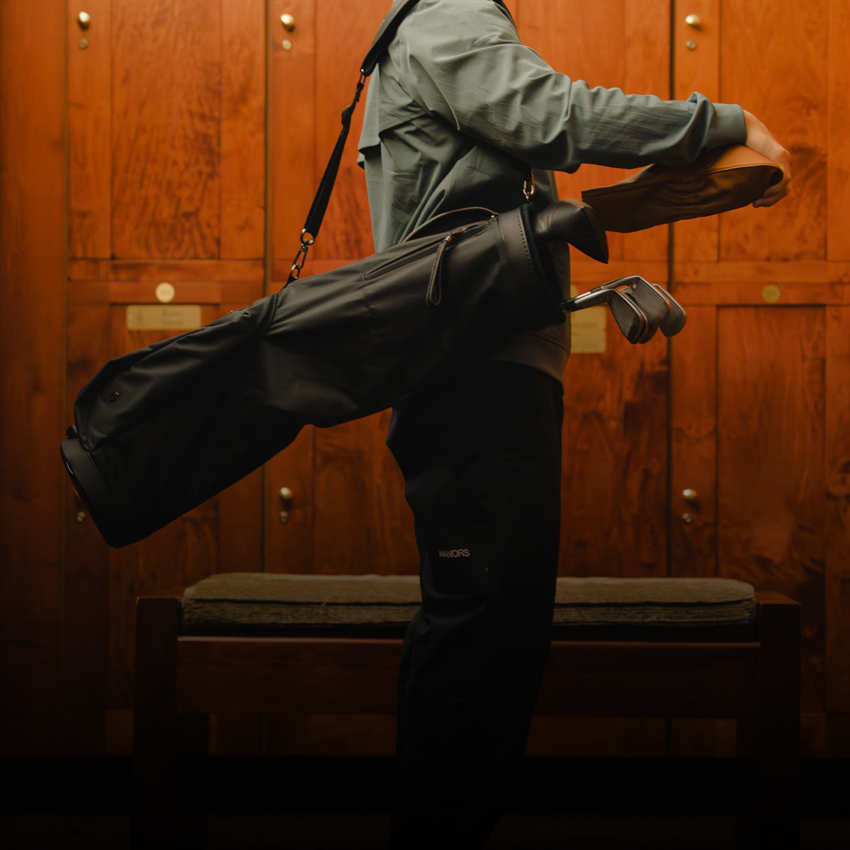 Man wearing Sunday Carry Golf Bag in locker room