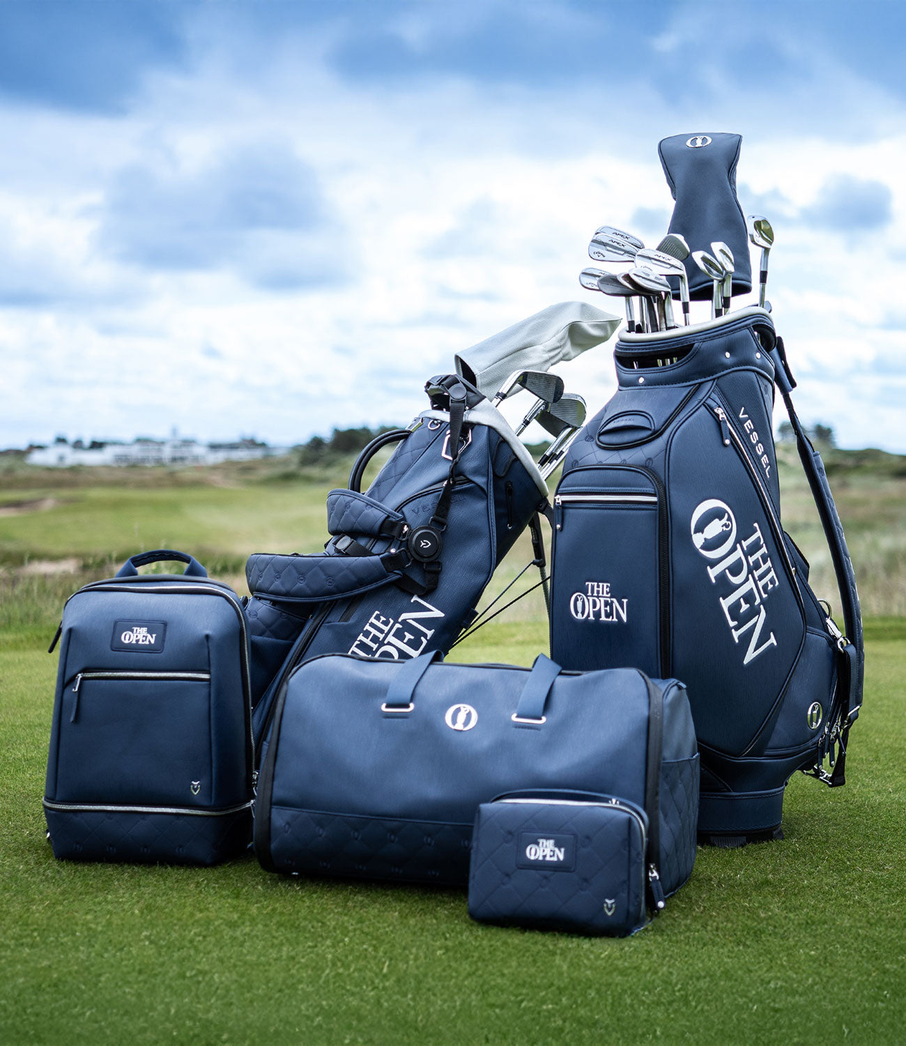 2 blue golf bags and 3 blue lifestyle bags on a golf course to celebrate The Open.