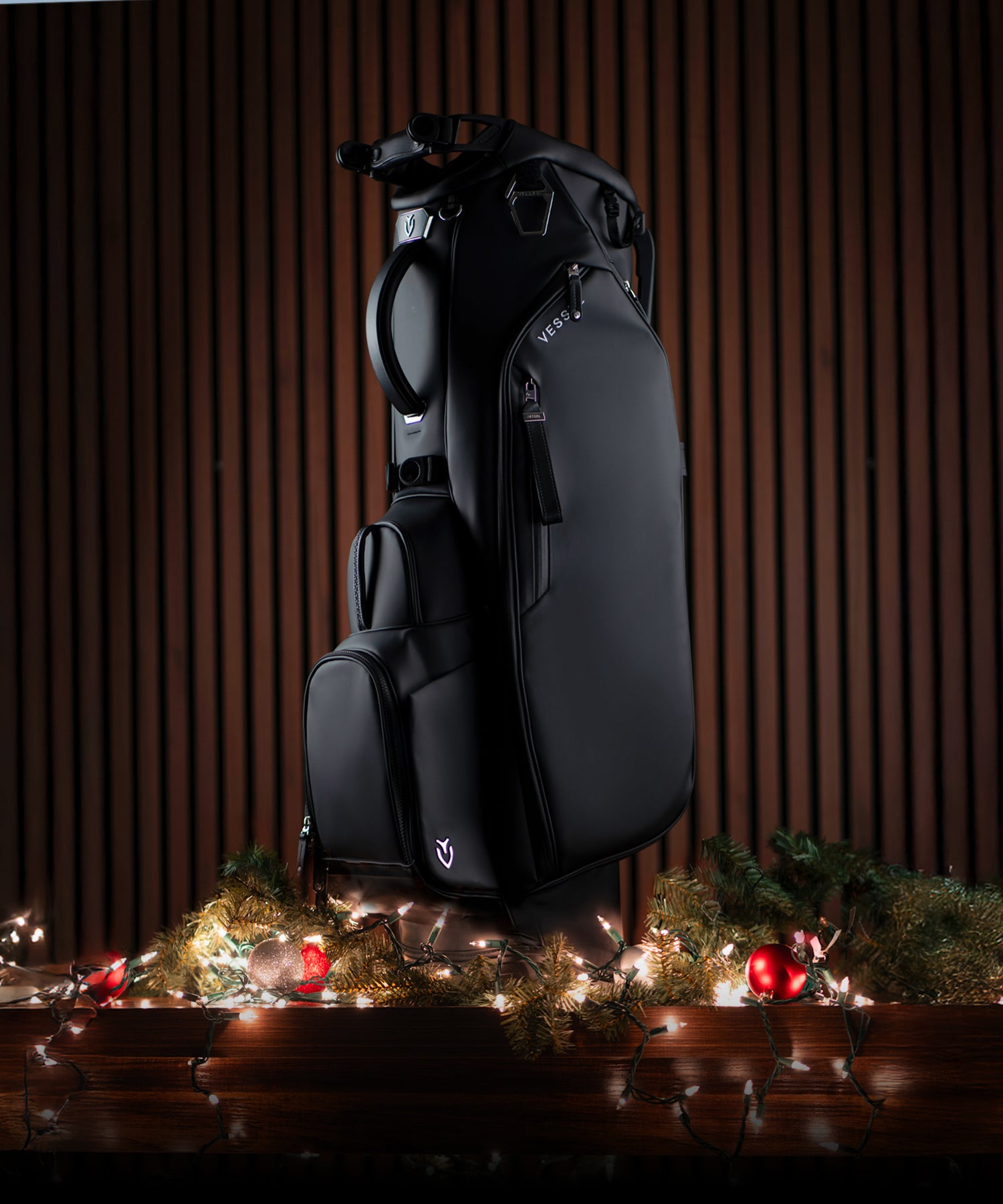 Black Player V golf bag on top of Christmas lights