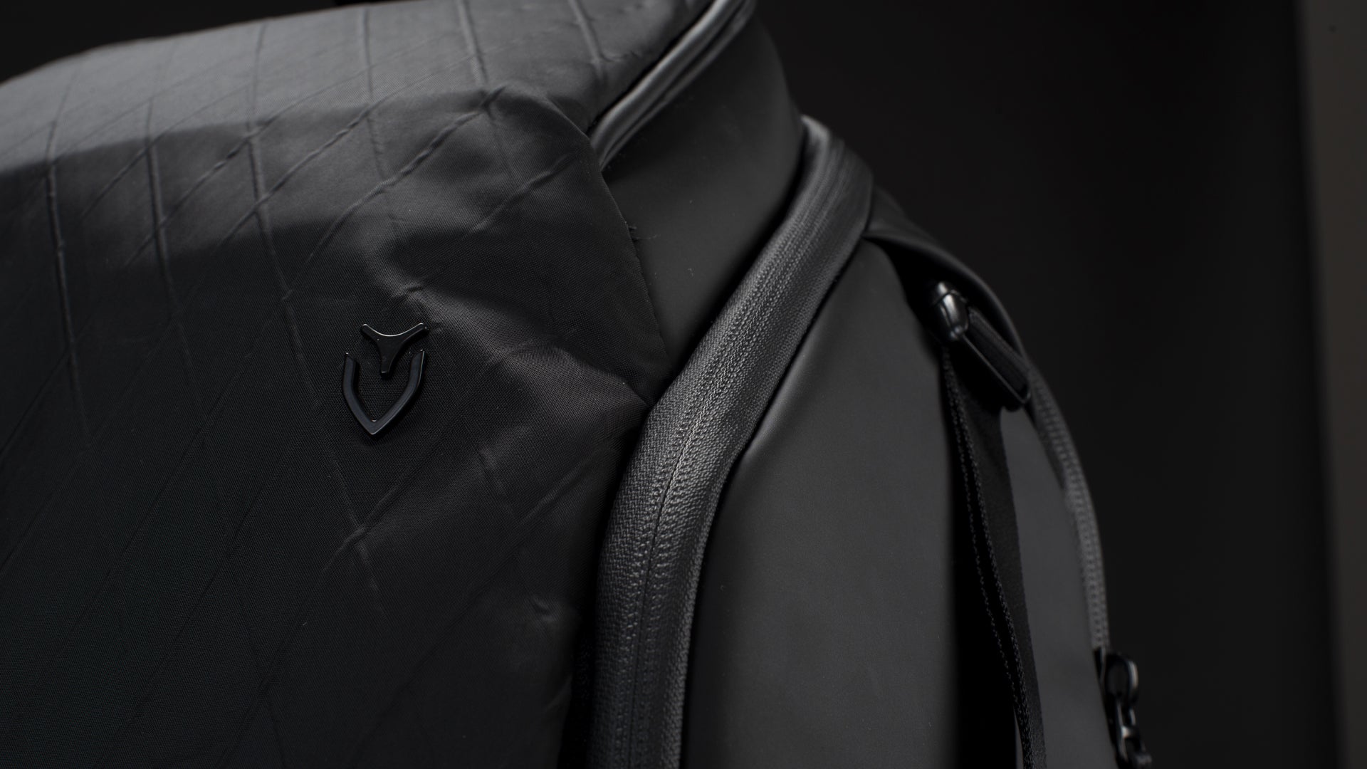 Close up shot of a black PrimeX Backpack in a black studio