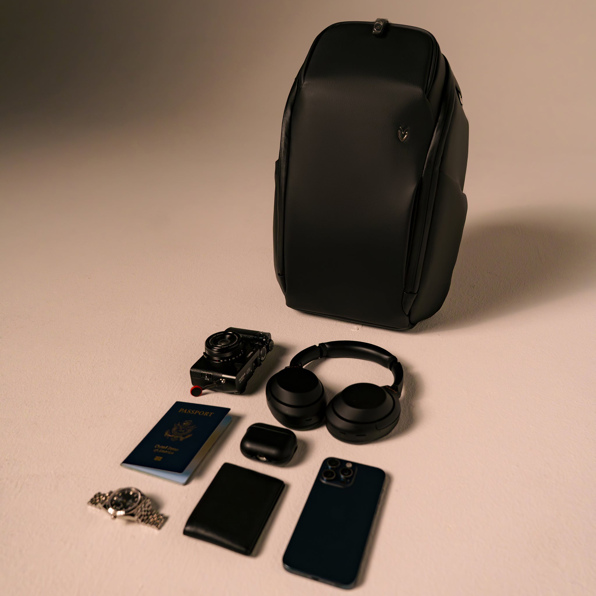 Black PrimeX 2.0 Plus Backpack with daily items laying around it