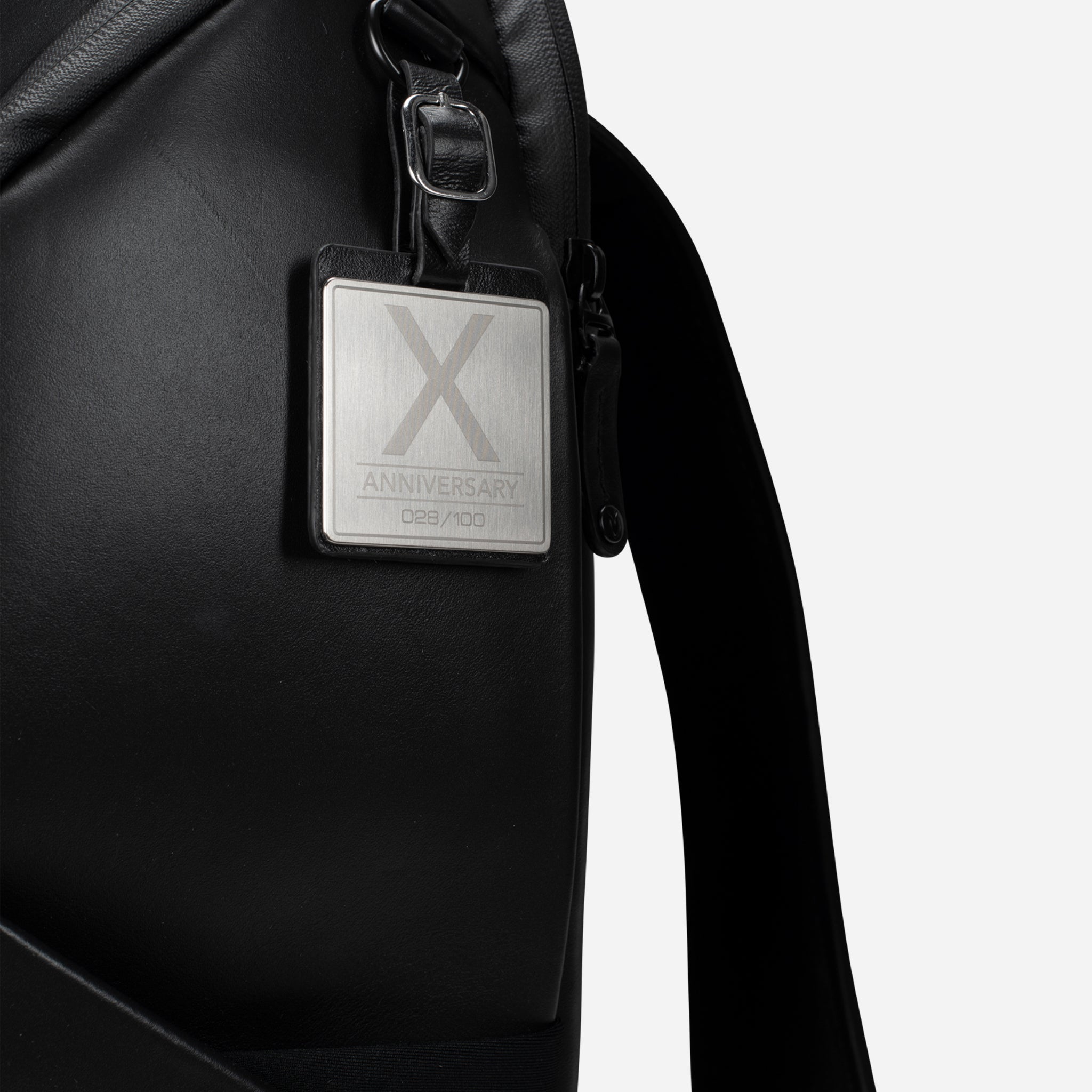 Close up of metal ID badge for PrimeX Carbon Black Backpack
