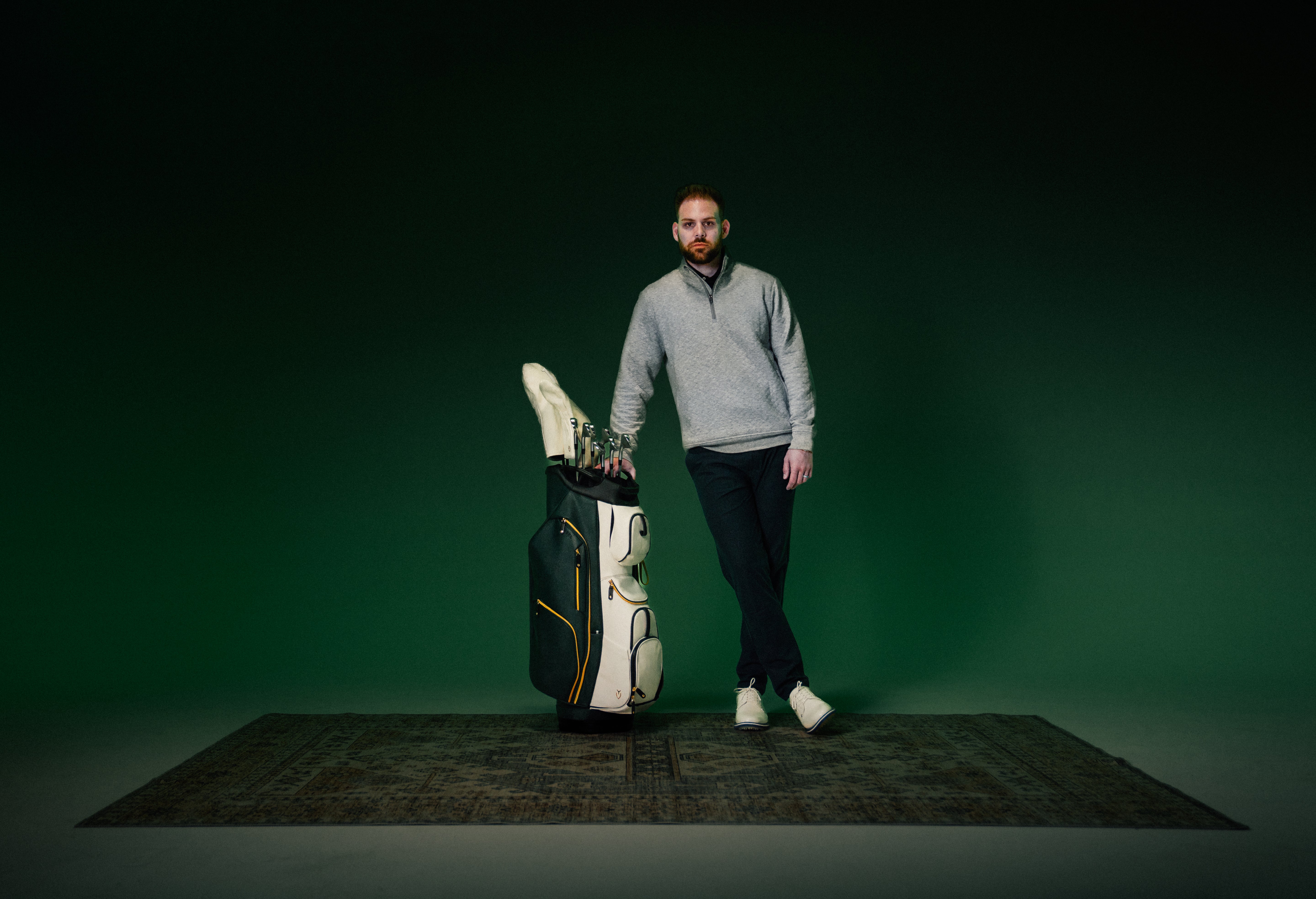 Model standing next to 2025 Season Opener Lux Pro Cart on a green background.