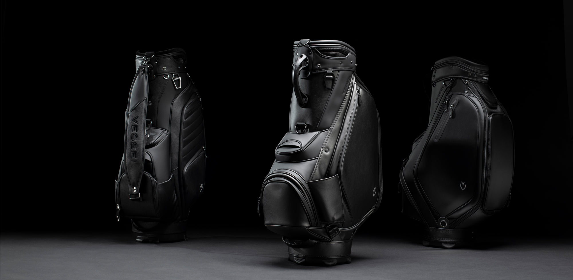 3 black leather staff bags on a black background