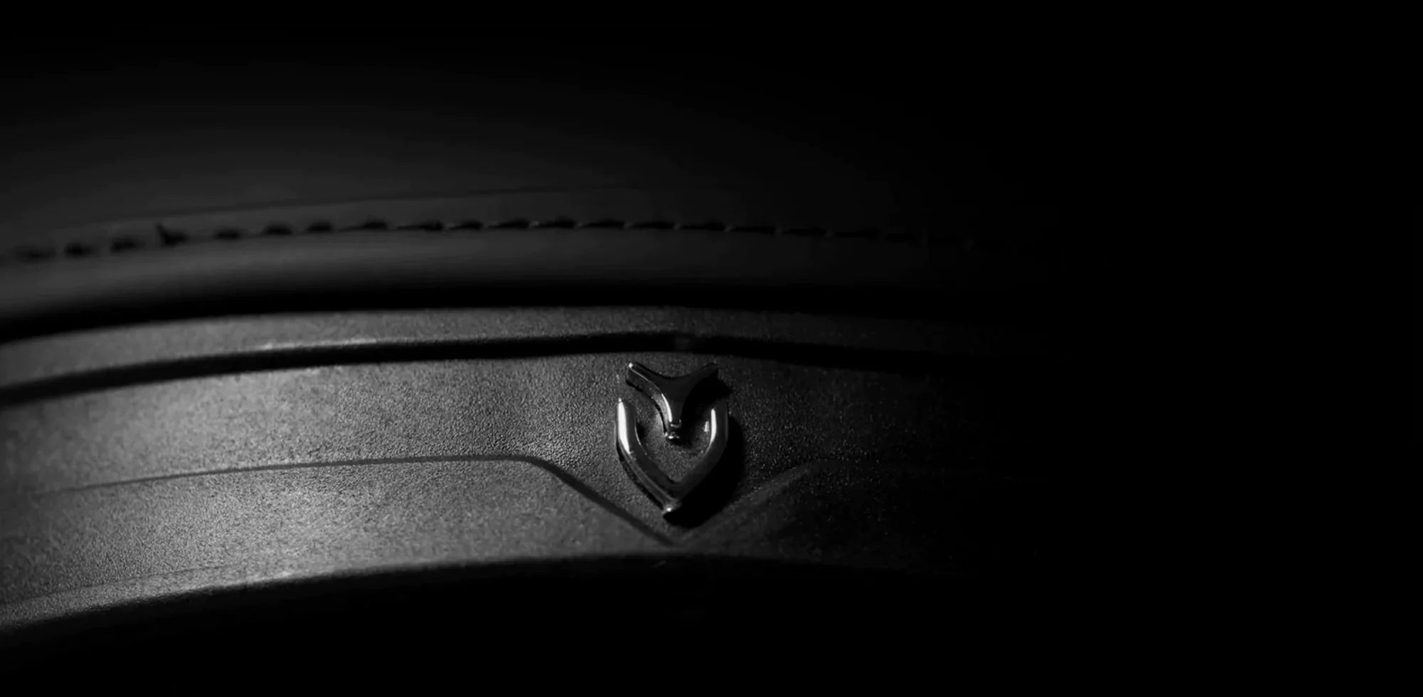 Close up image of the dark VESSEL emblem on bottom of golf bag