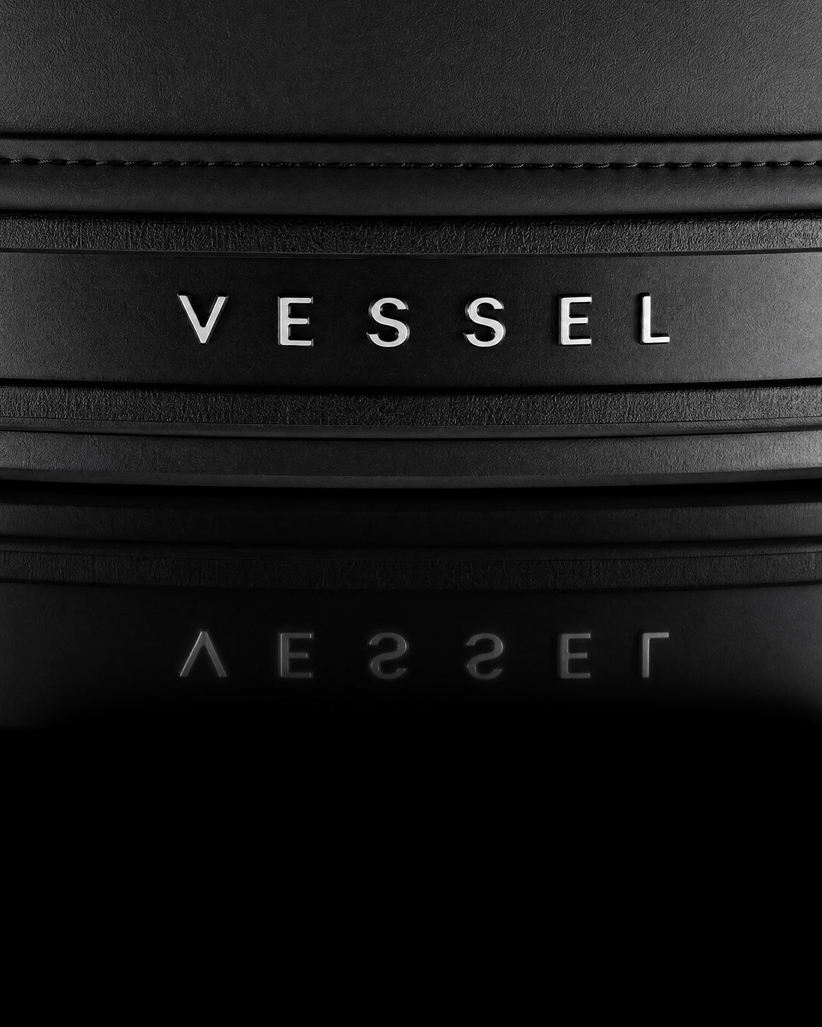 Close up image of the dark VESSEL emblem on bottom of golf bag