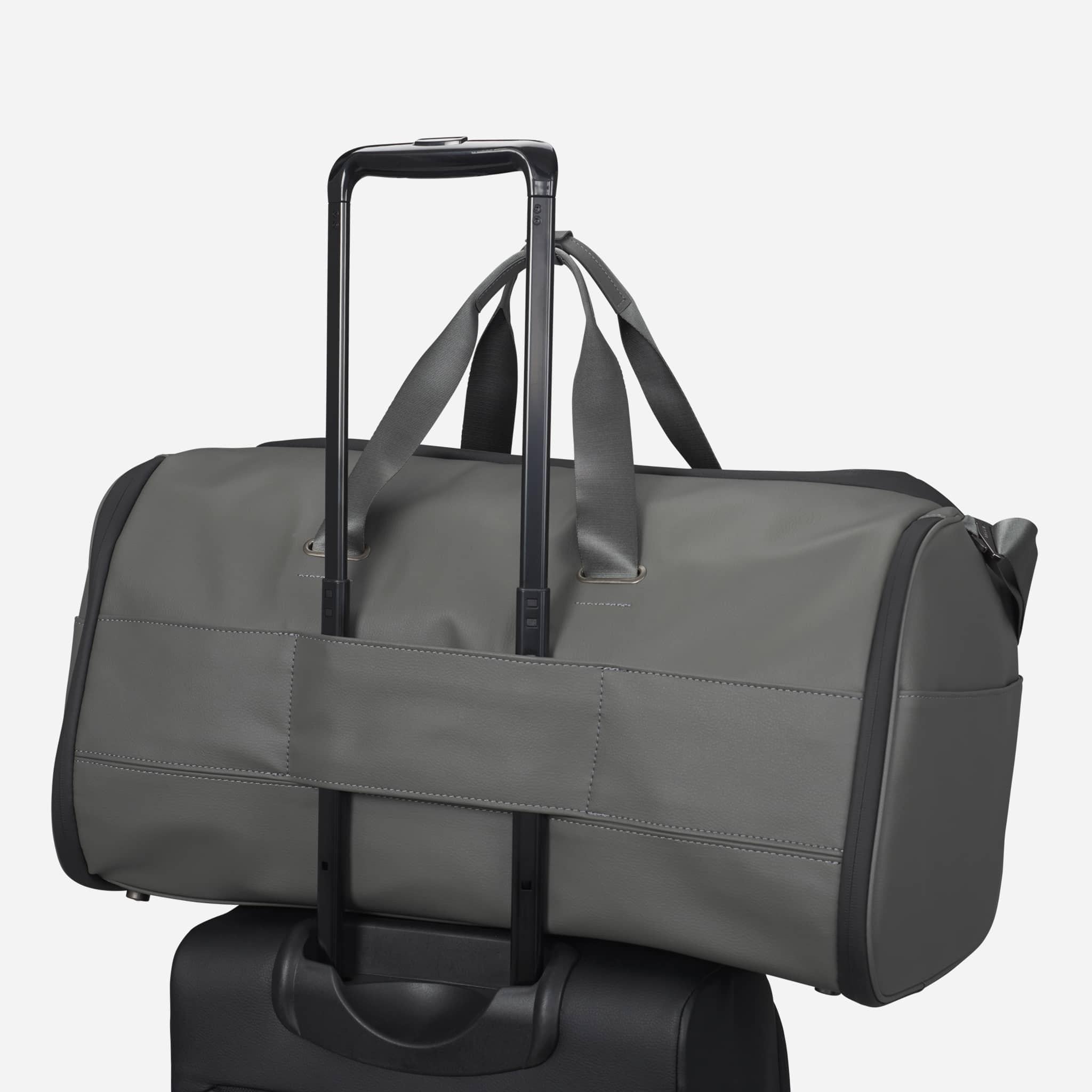Grey Signature Garment Duffel on top of suitcase #color_pebbled grey