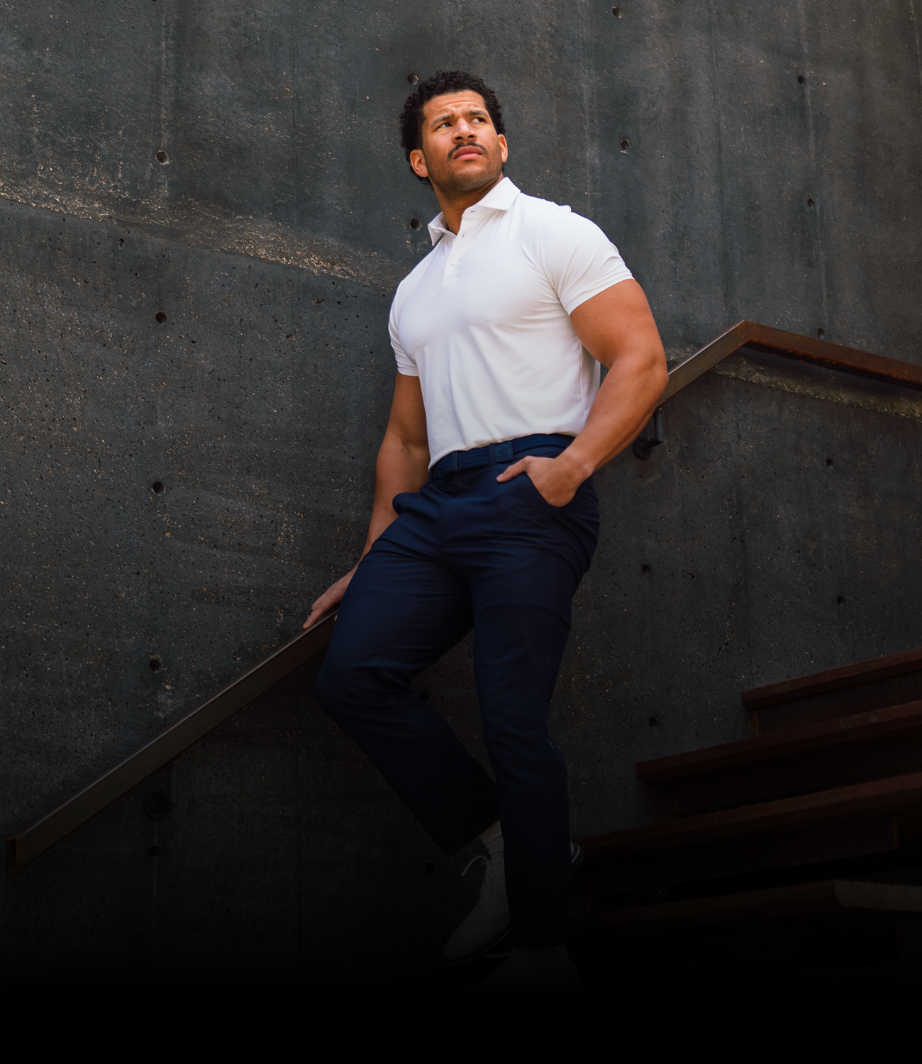 Man walking down stairs in Vessel Golf Apparel