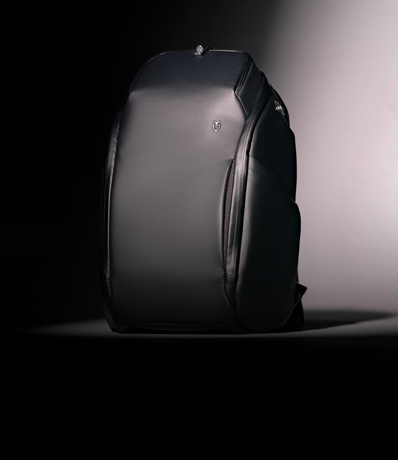 Black leather backpack in a spotlight