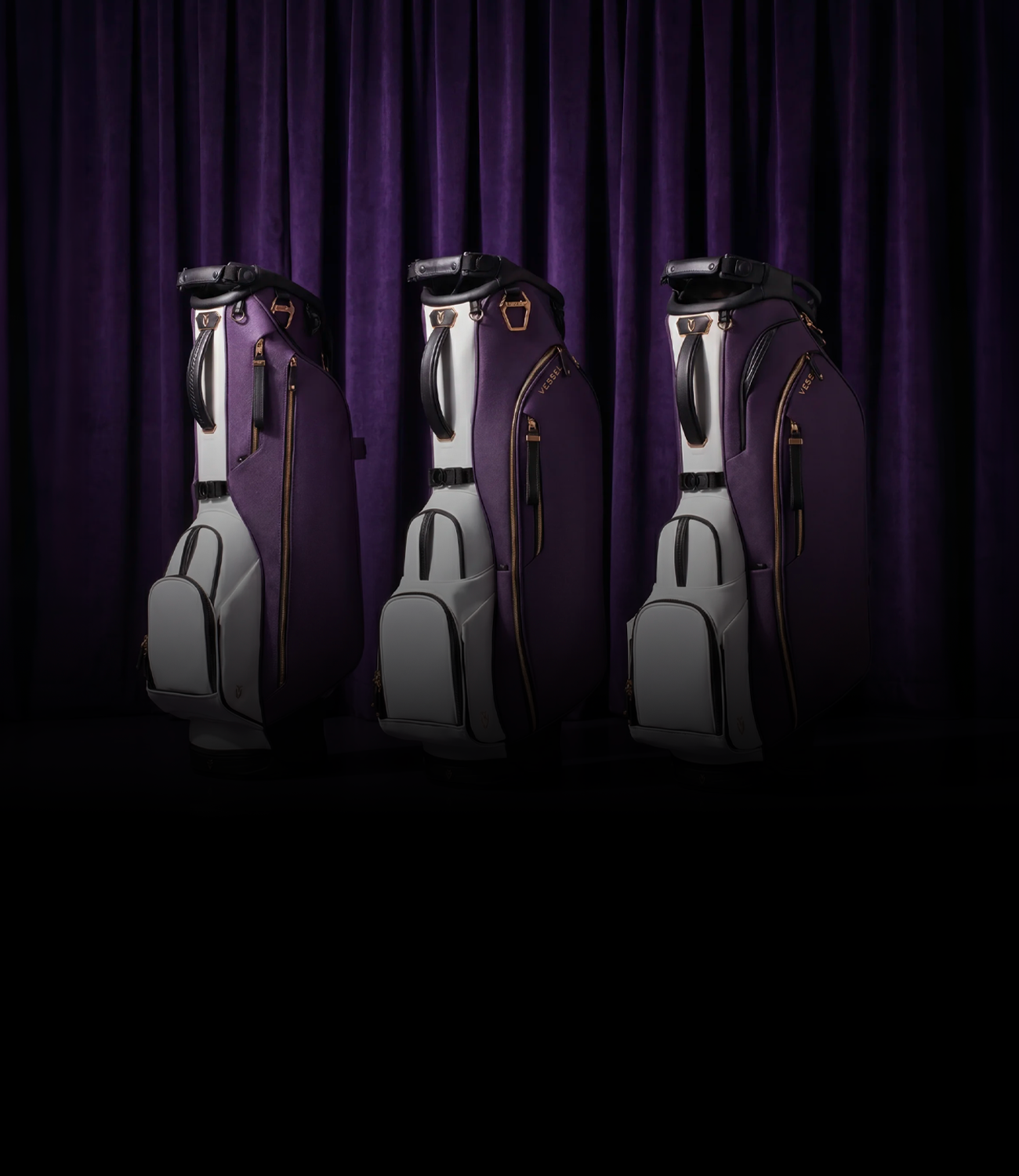 Three purple leather golf bags in front of a dark purple curtain