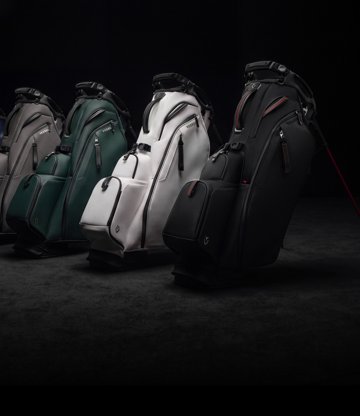 five Player VI Pro golf bags lined up against a dark grey background