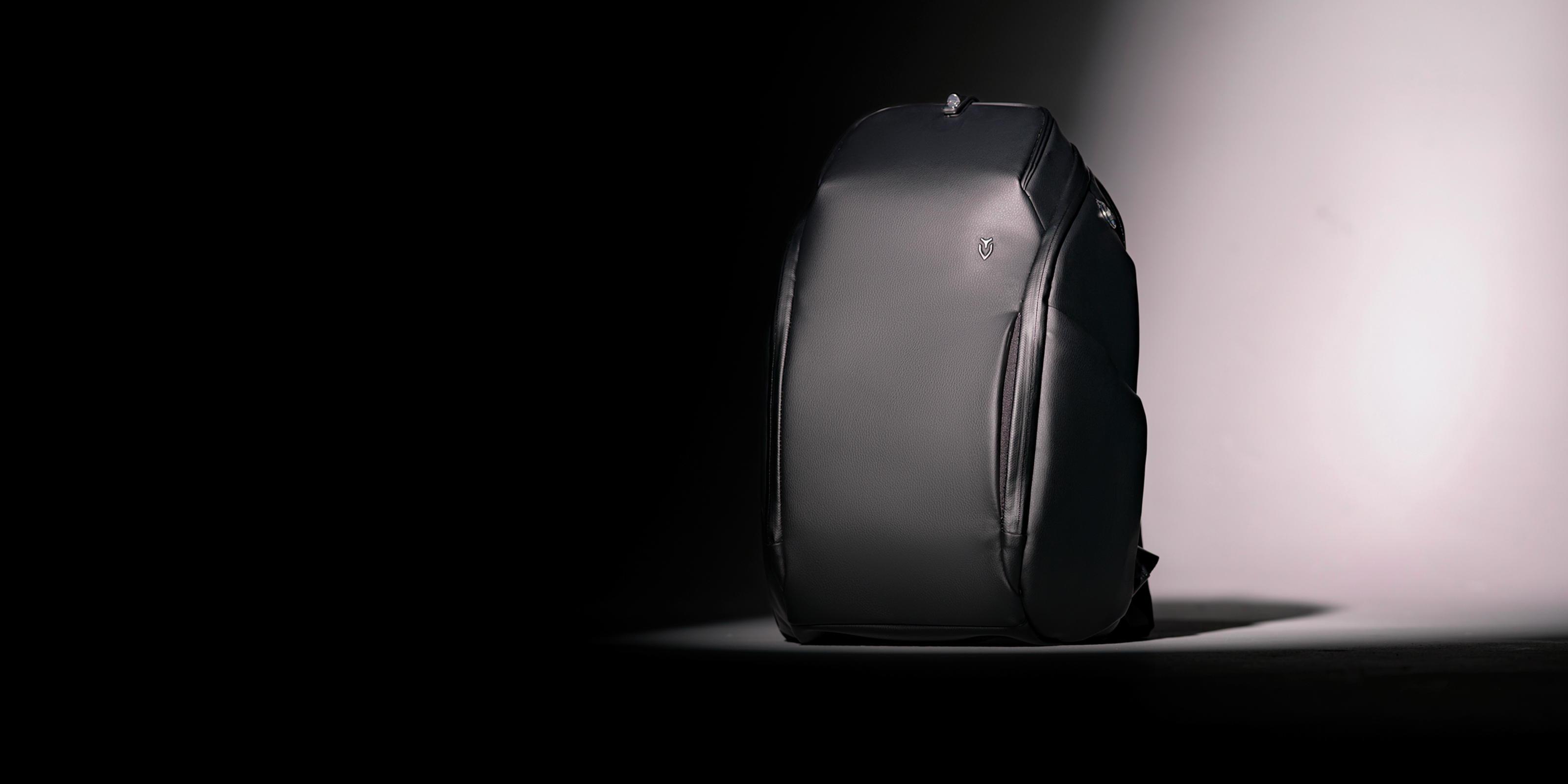 Black leather backpack in a spotlight
