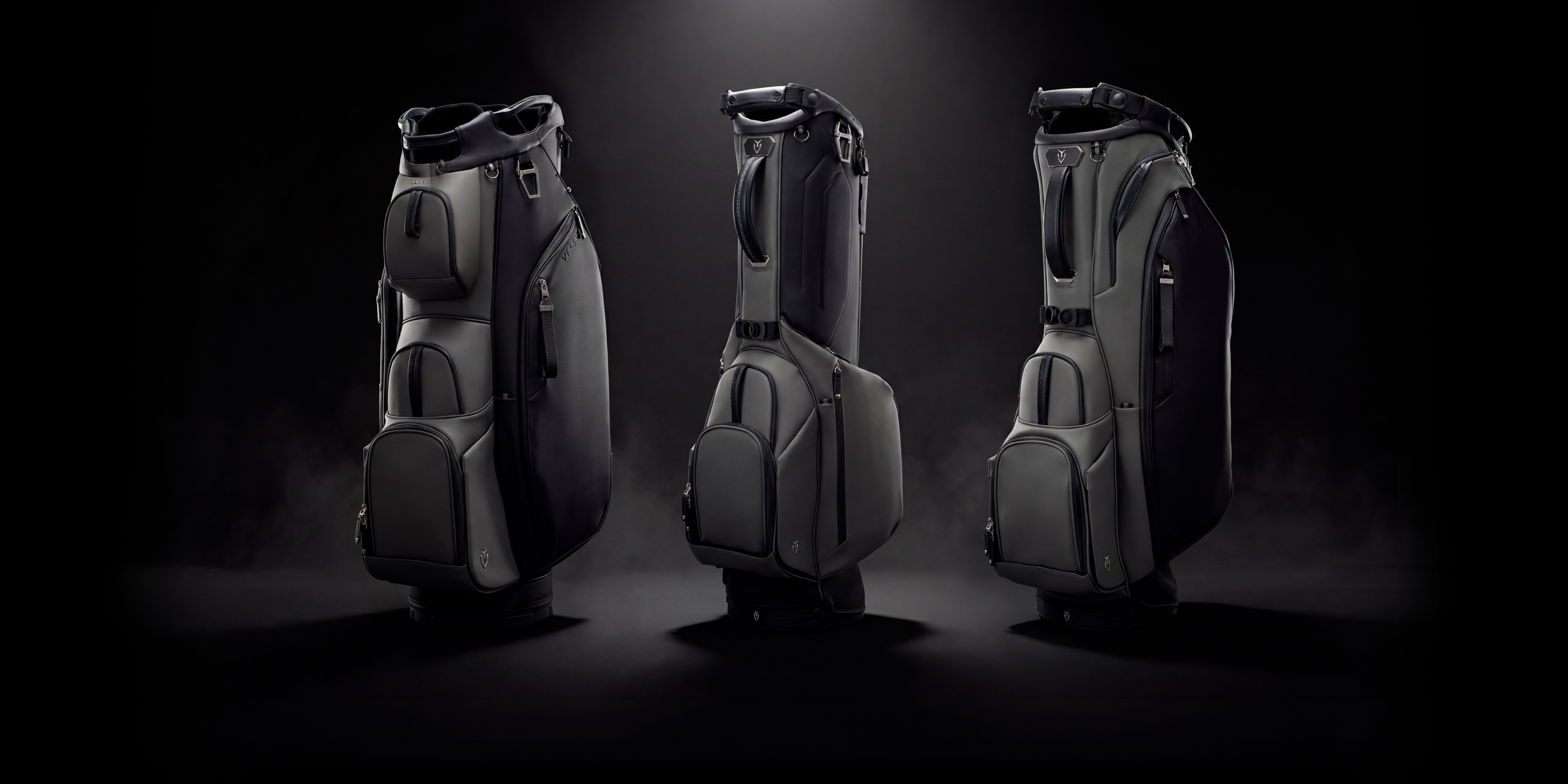 Three golf bags in the phantom colorway on a dark background