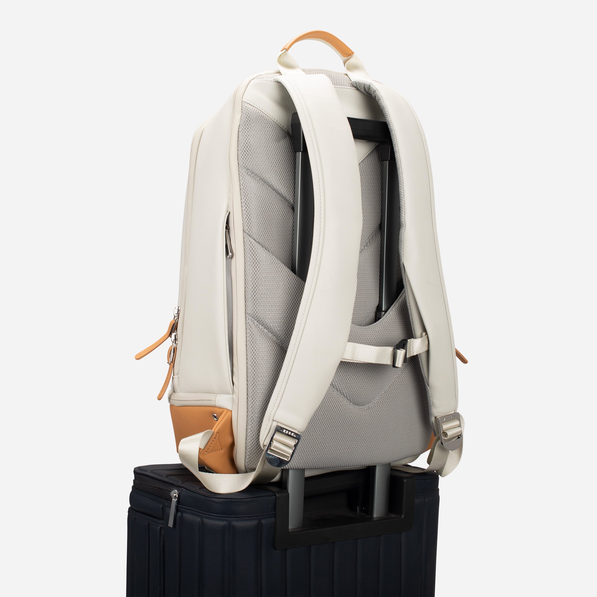 Latte Signature Plus Backpack on top of suitcase