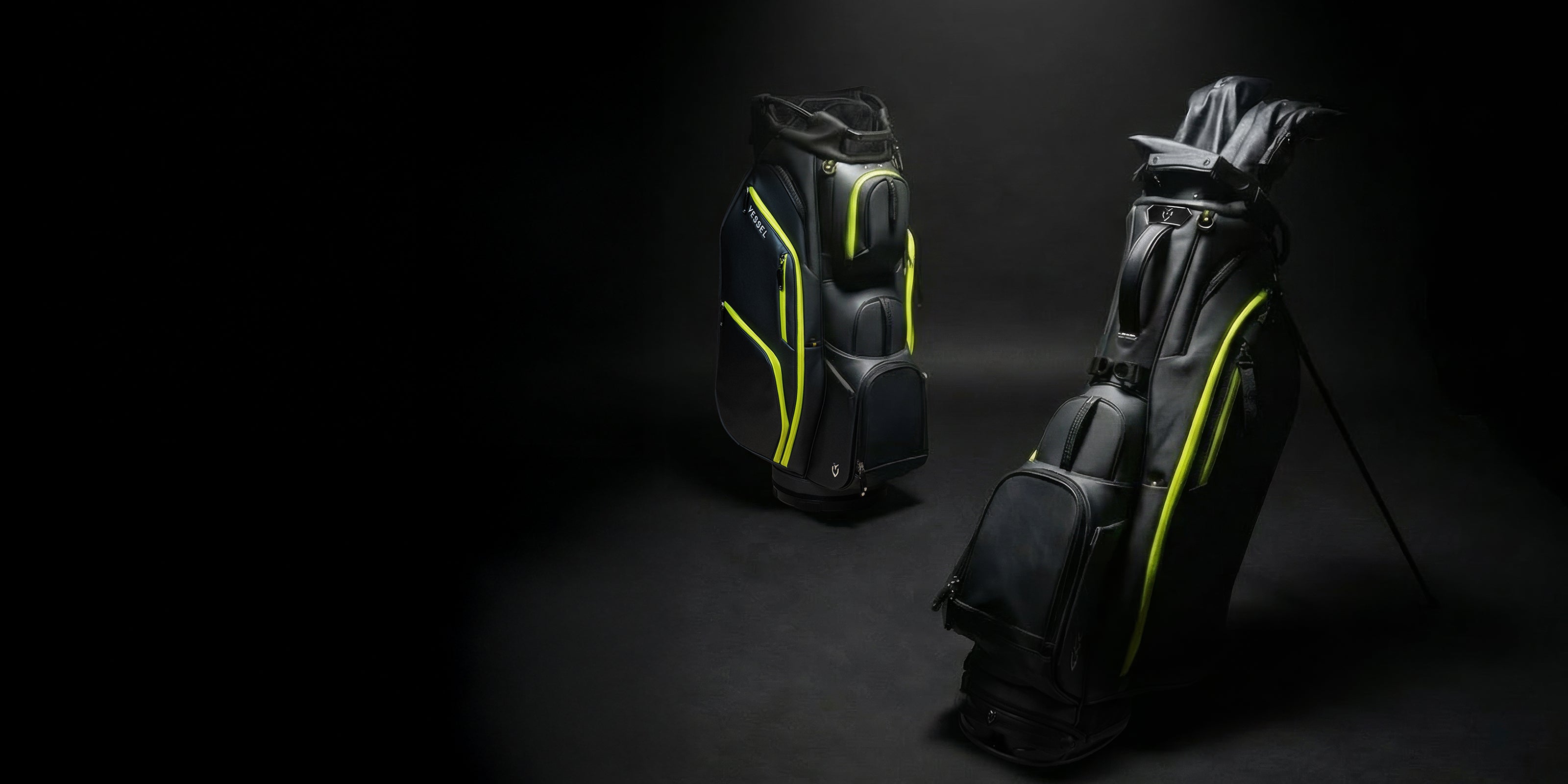 Two black and neon yellow golf bags against a black background