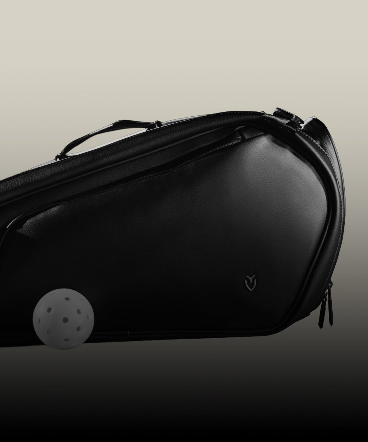 Black pickleball bag with a pickleball on a gradient background