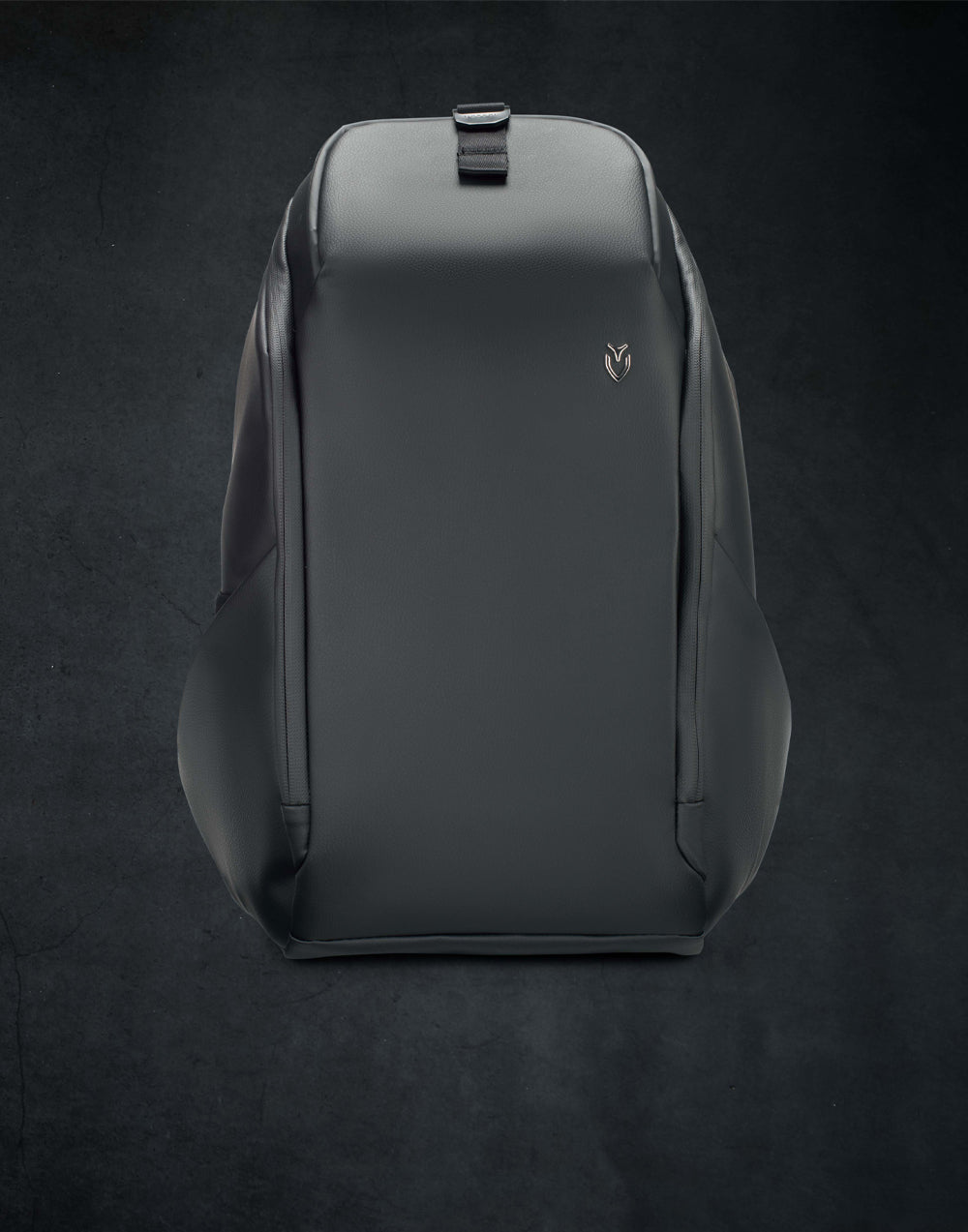Black leather backpack on a gray background