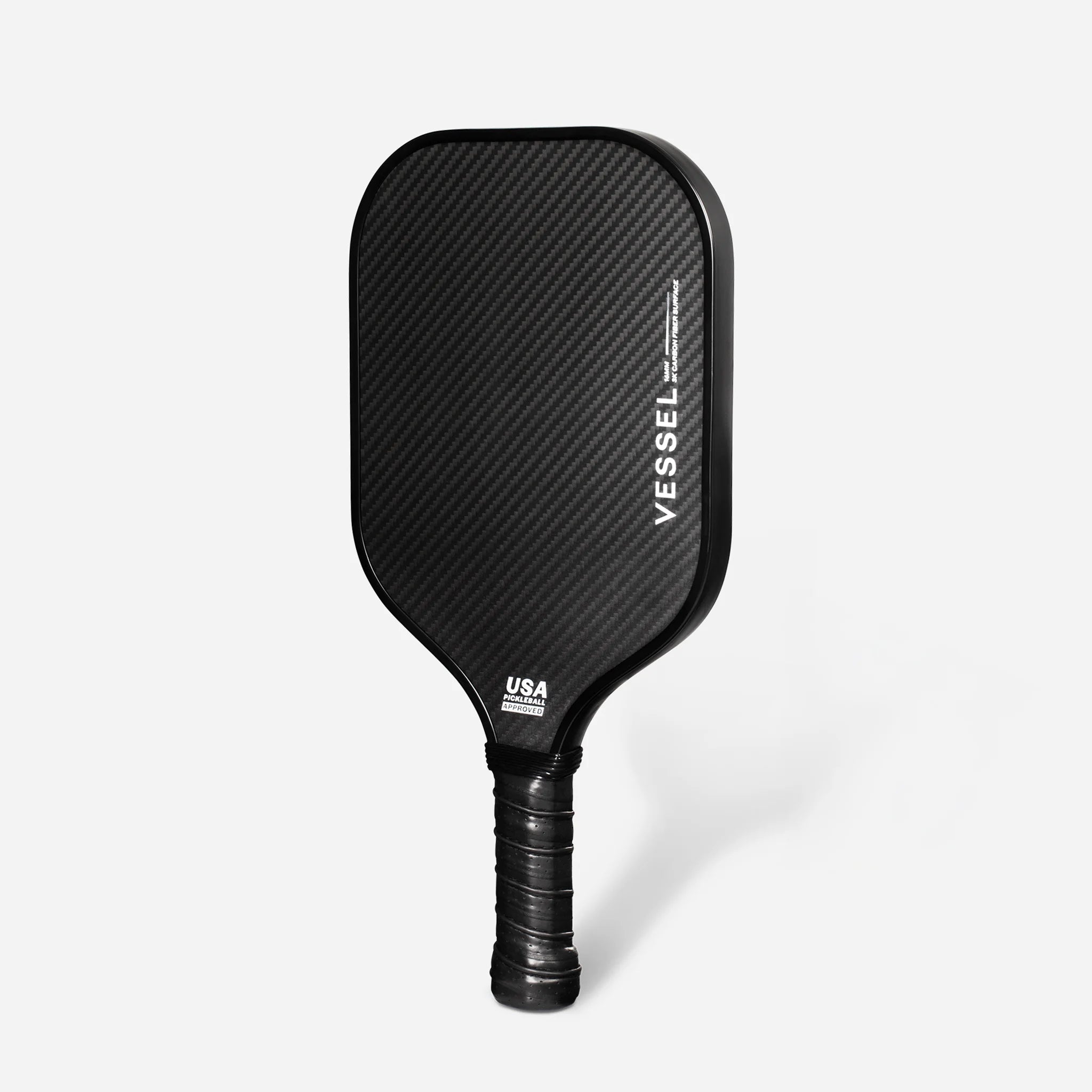 Backside of black carbon fiber pickleball paddle with Vessel branding on the face