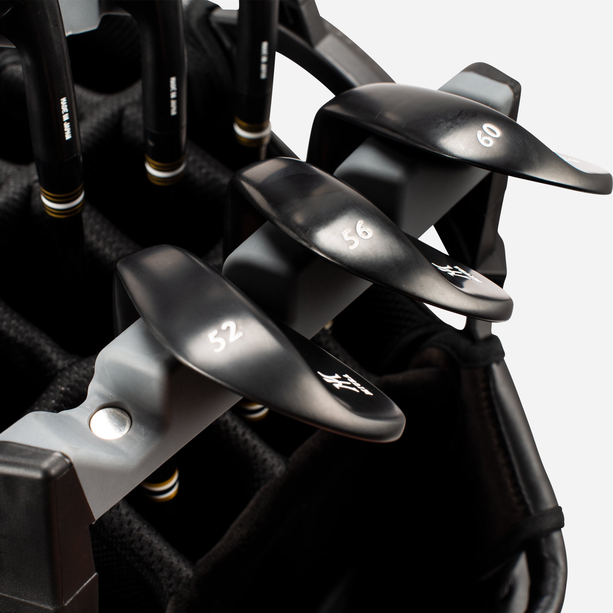 Close up of golf clubs in golf tray organizer on black golf cart bag