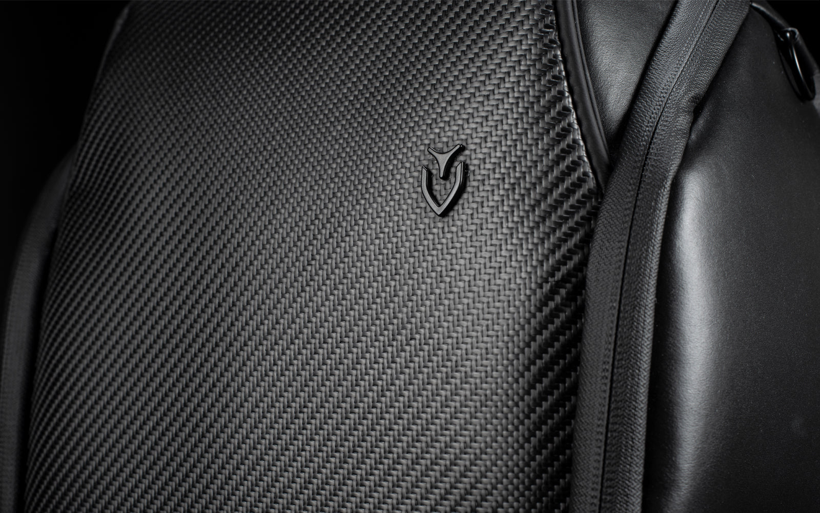 Close up of carbon fiber material on front of backpack with VESSEL emblem
