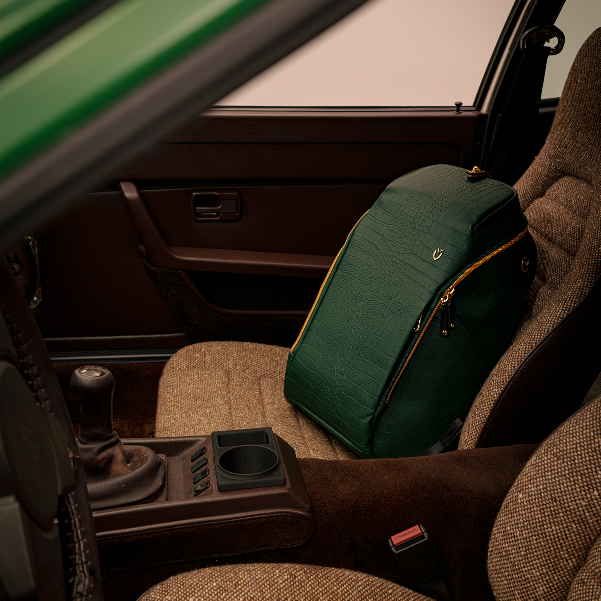 2026 Season Opener PrimeX 2.0 Backpack sitting in passenger seat of green porsche