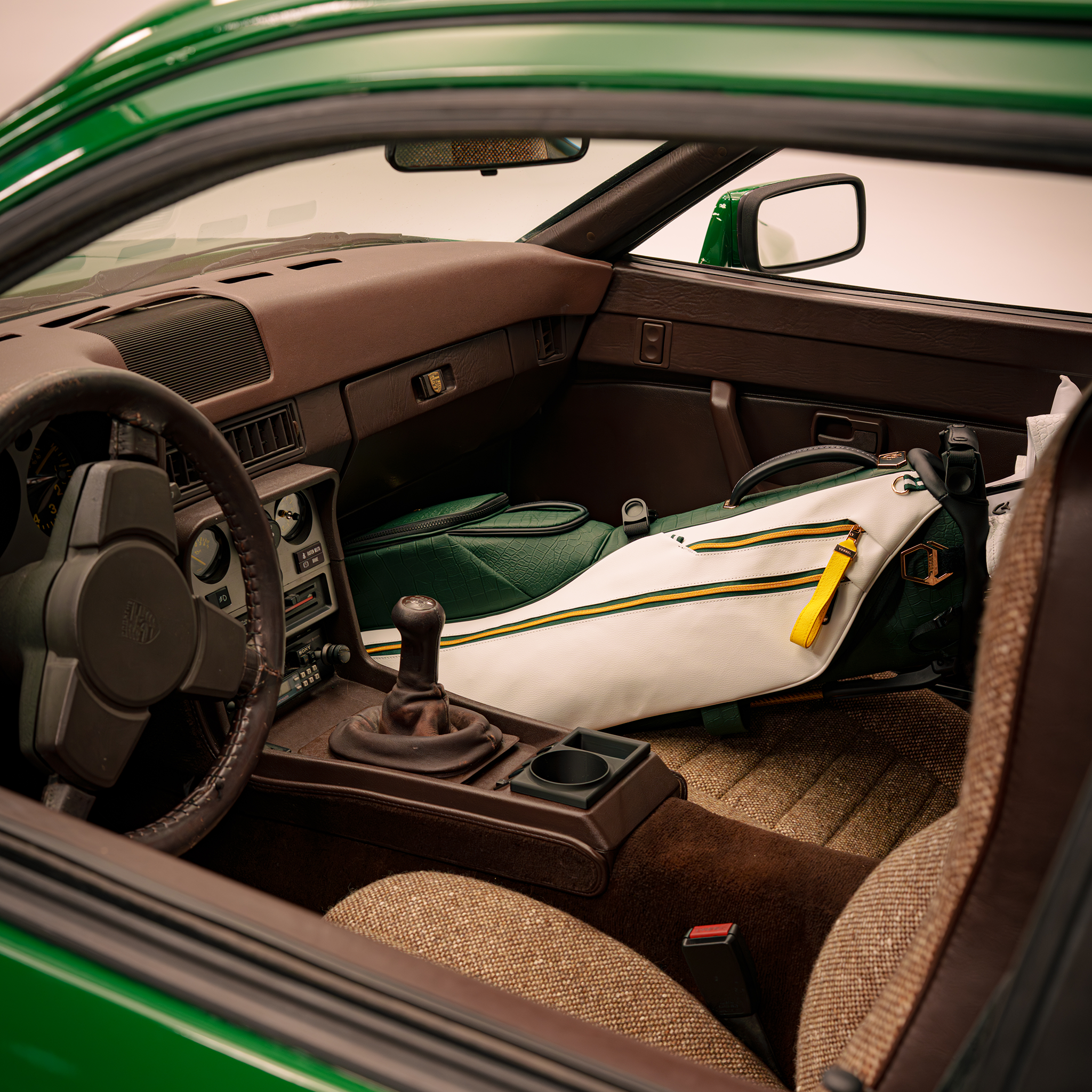 2026 Season Opener Lux Stand sitting in passenger seat of green porsche